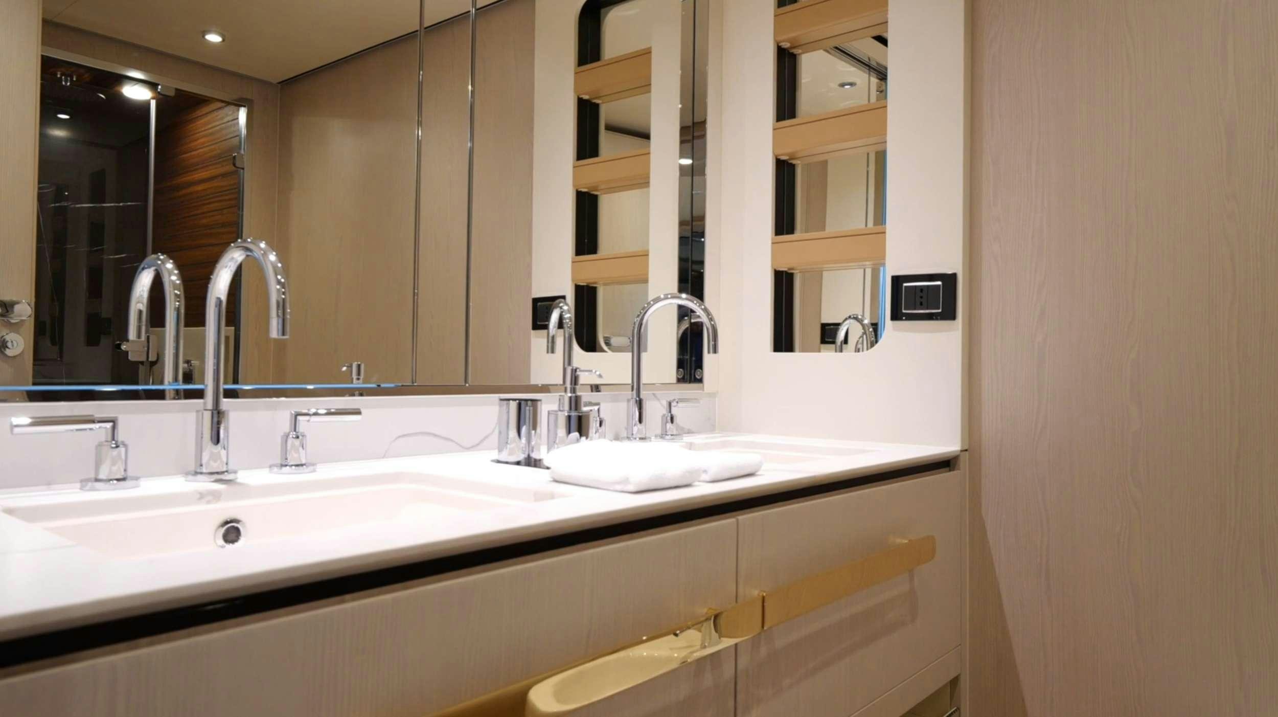 a bathroom with a sink and a mirror aboard PARADISE PEARL Yacht for Charter