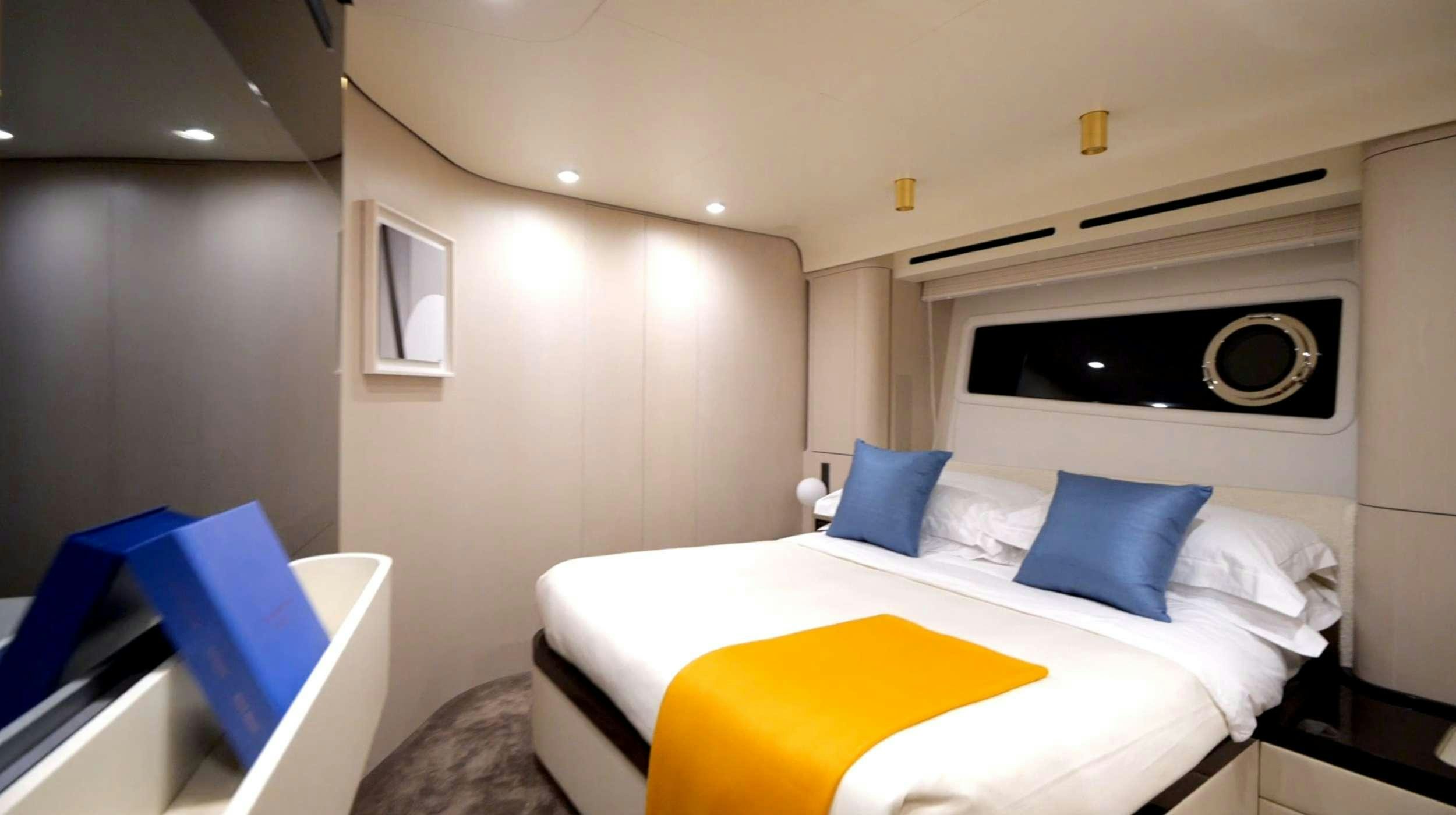 a room with a bed and a fireplace aboard PARADISE PEARL Yacht for Charter
