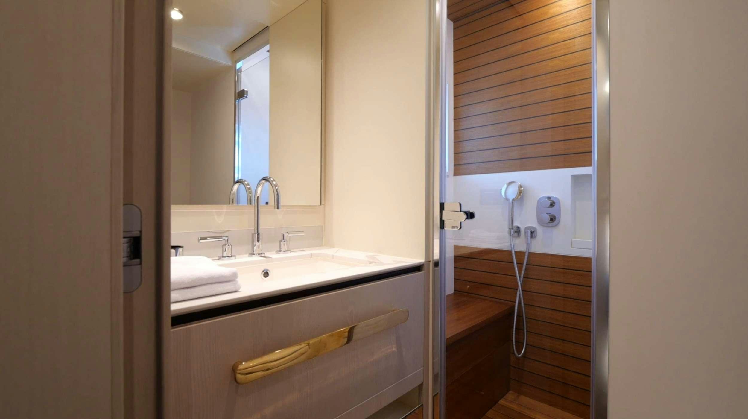 a bathroom with a sink and a mirror aboard PARADISE PEARL Yacht for Charter
