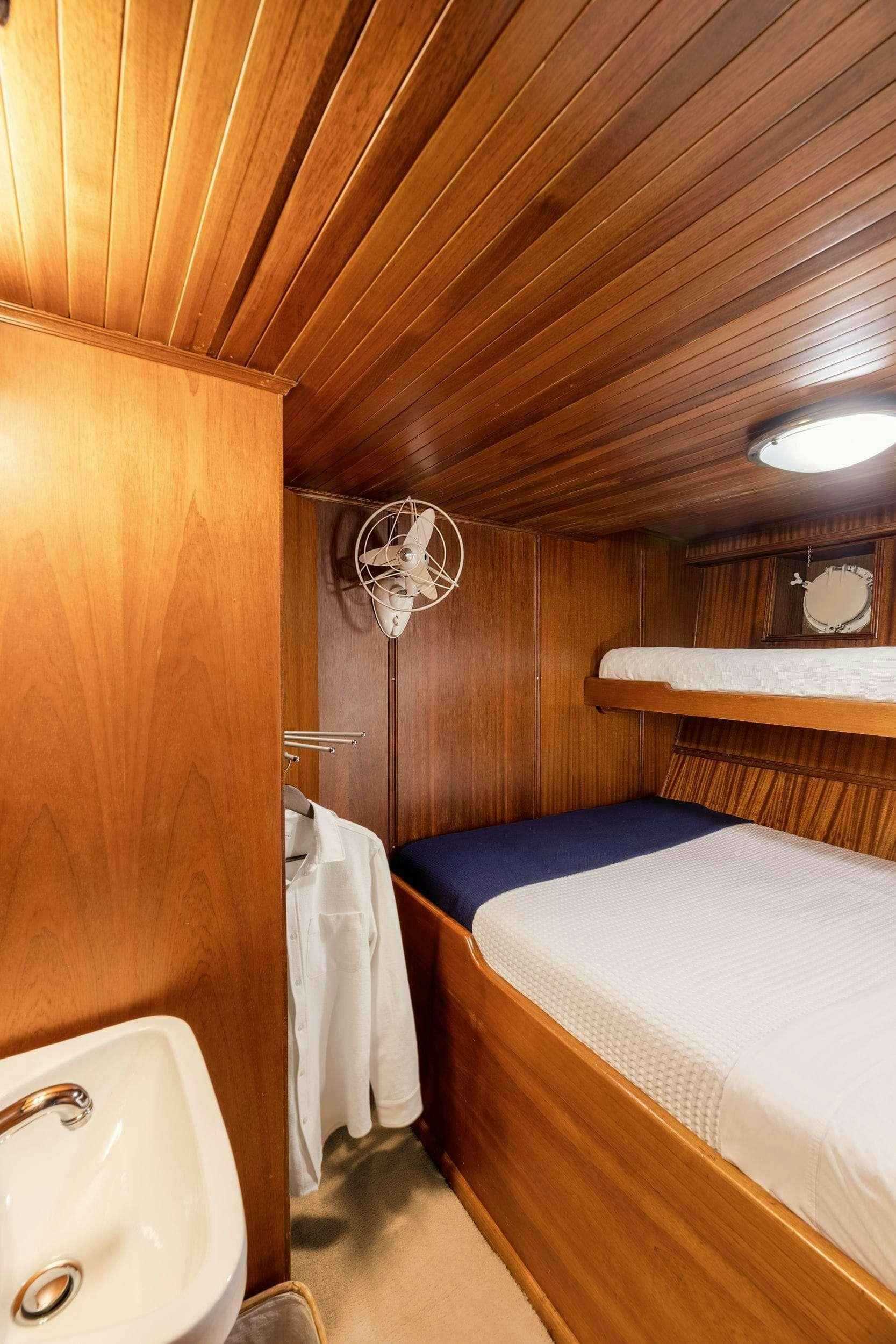 a small bathroom with a bed aboard LITHI Yacht for Charter