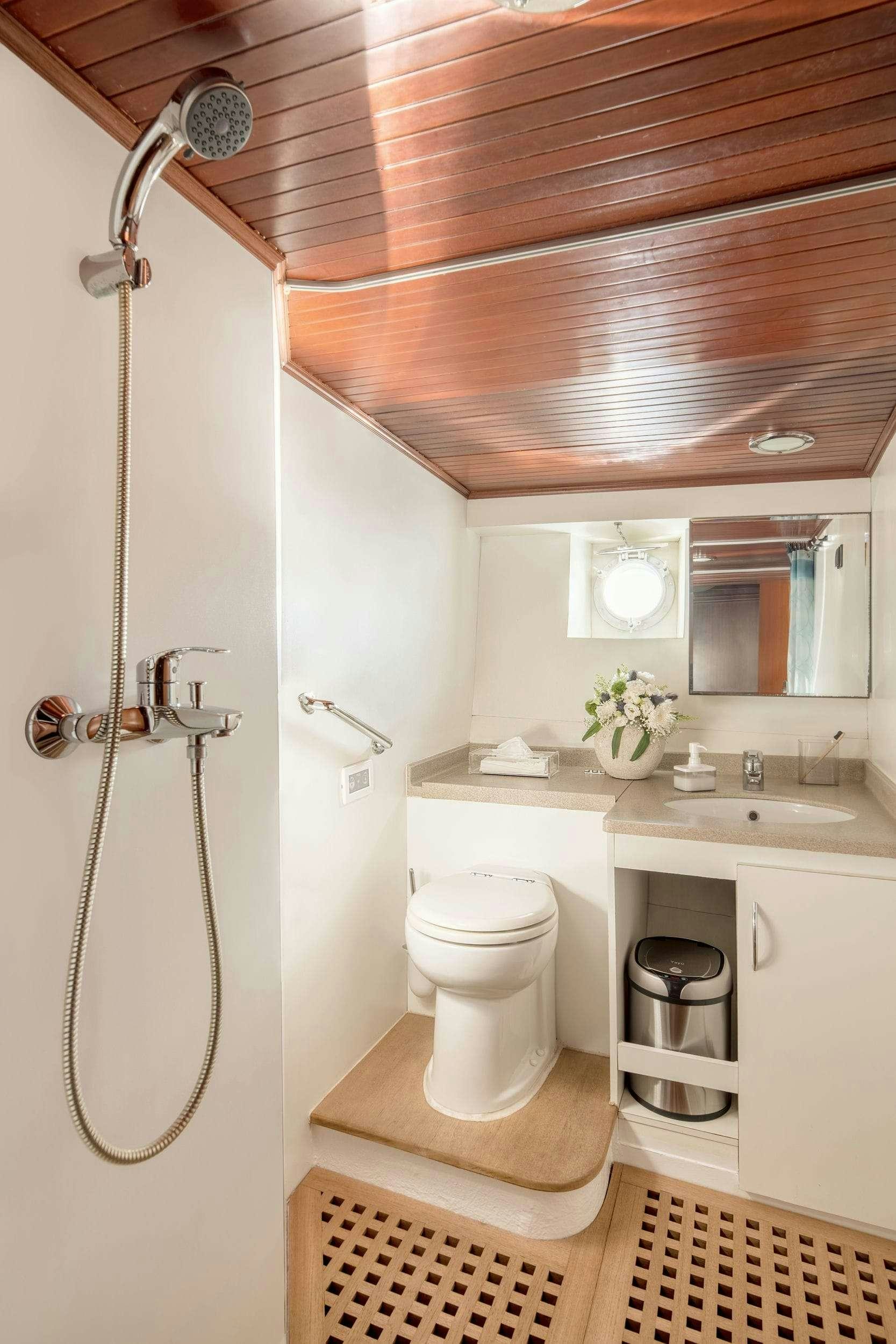 a bathroom with a toilet and sink aboard LITHI Yacht for Charter