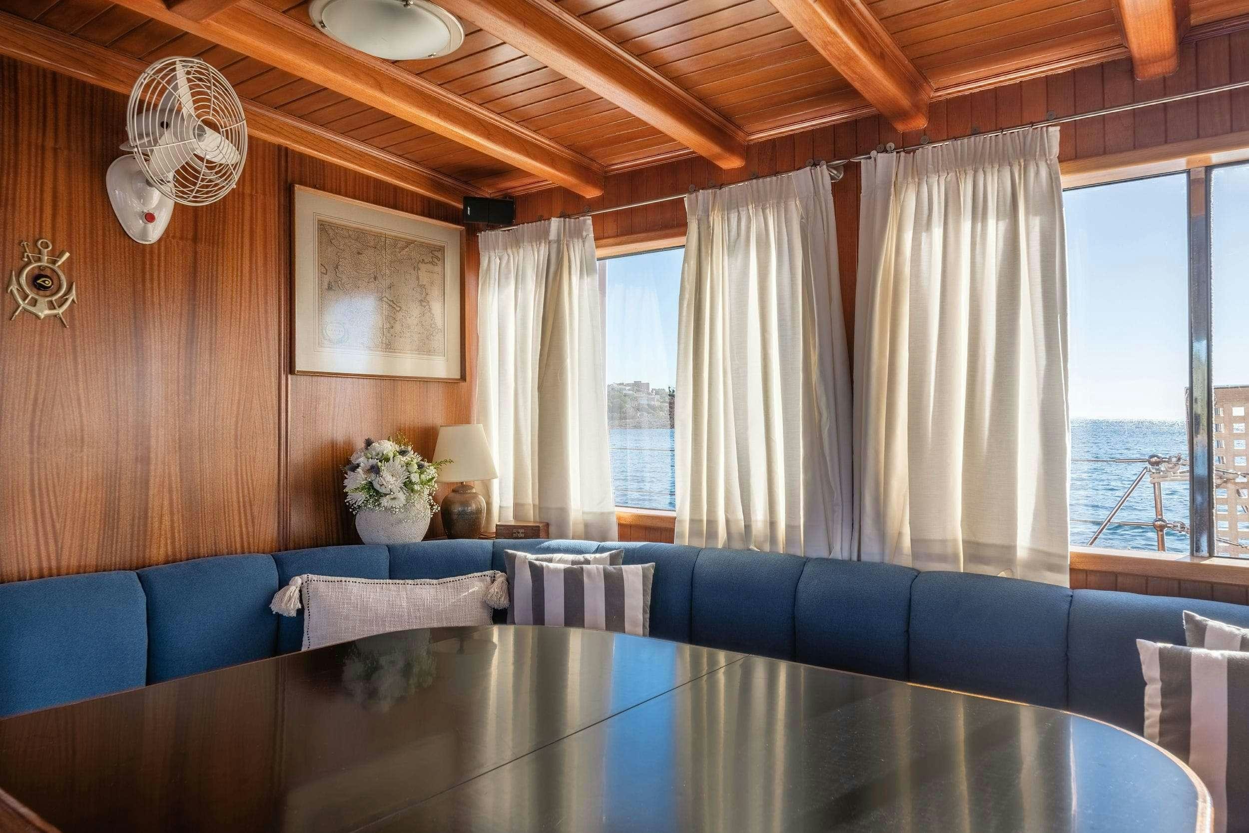 a room with a table and chairs aboard LITHI Yacht for Charter