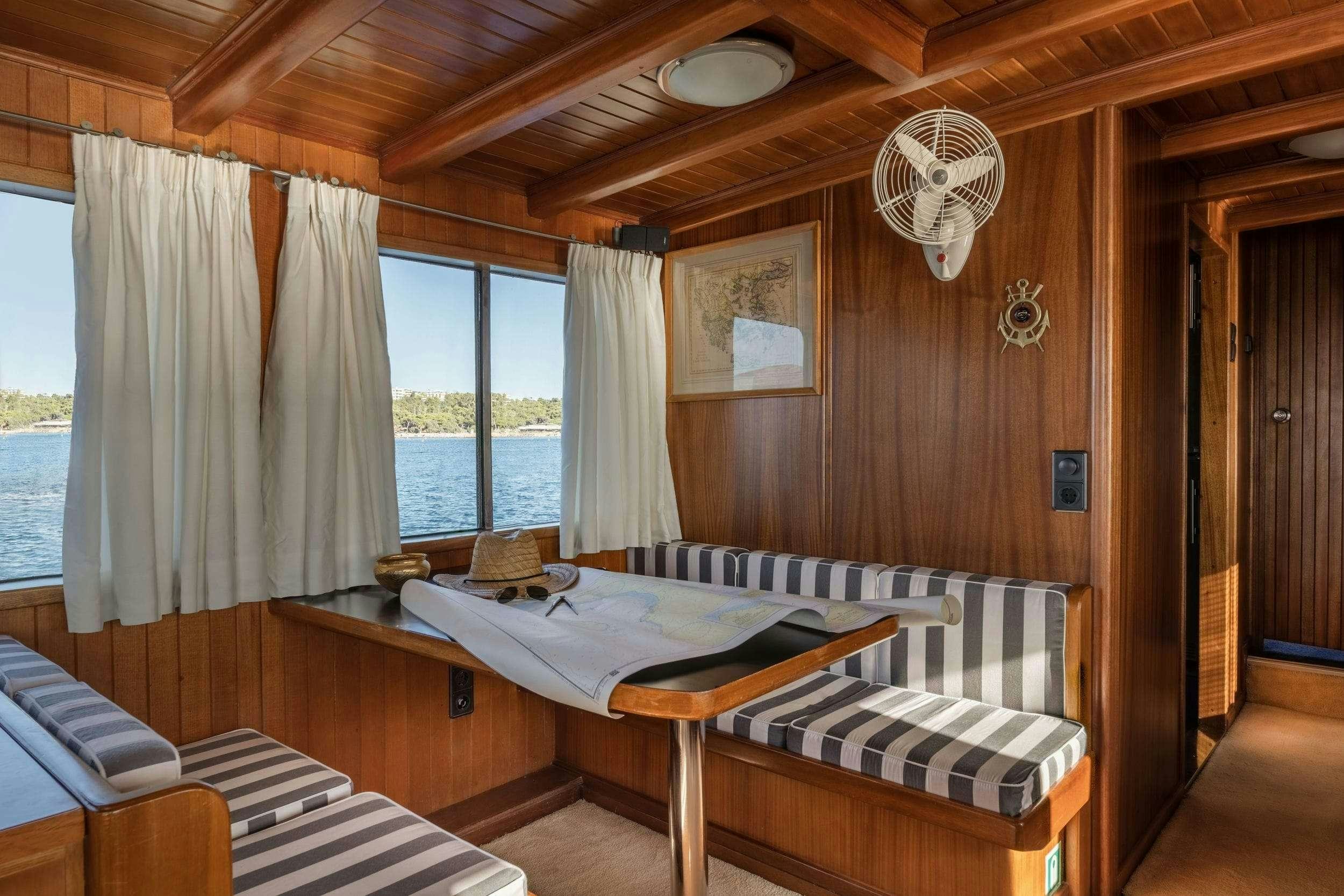 a room with a bed and a table aboard LITHI Yacht for Charter