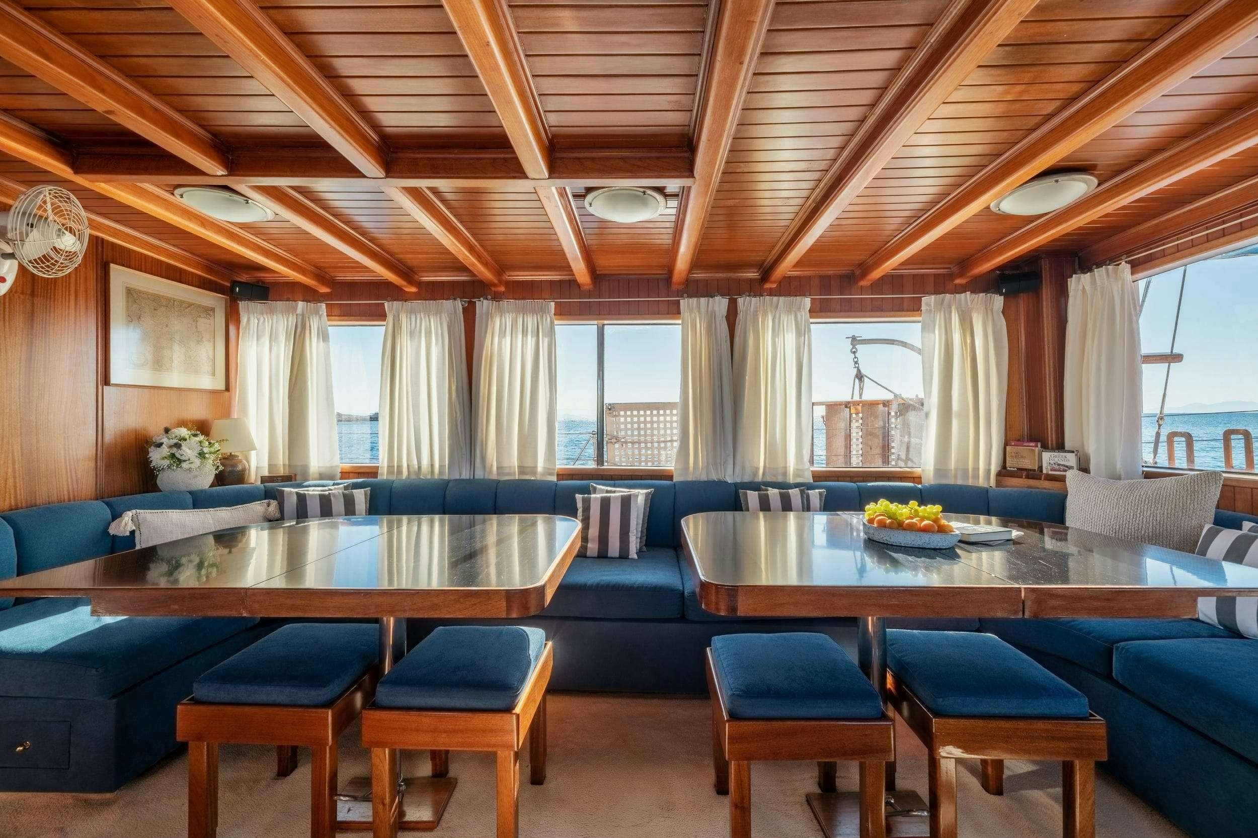 a room with a table and chairs aboard LITHI Yacht for Charter