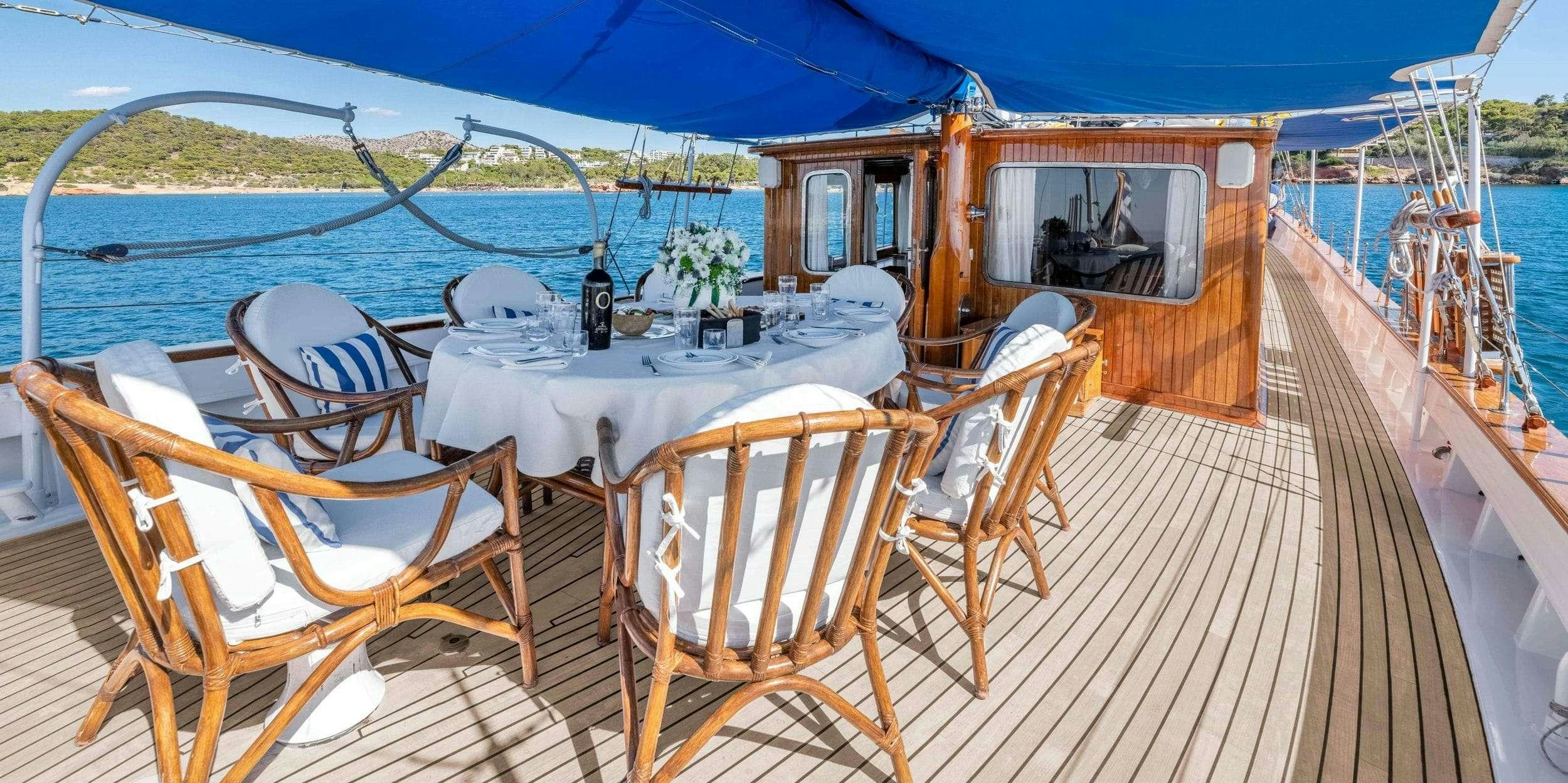 a deck with chairs and tables on it aboard LITHI Yacht for Charter