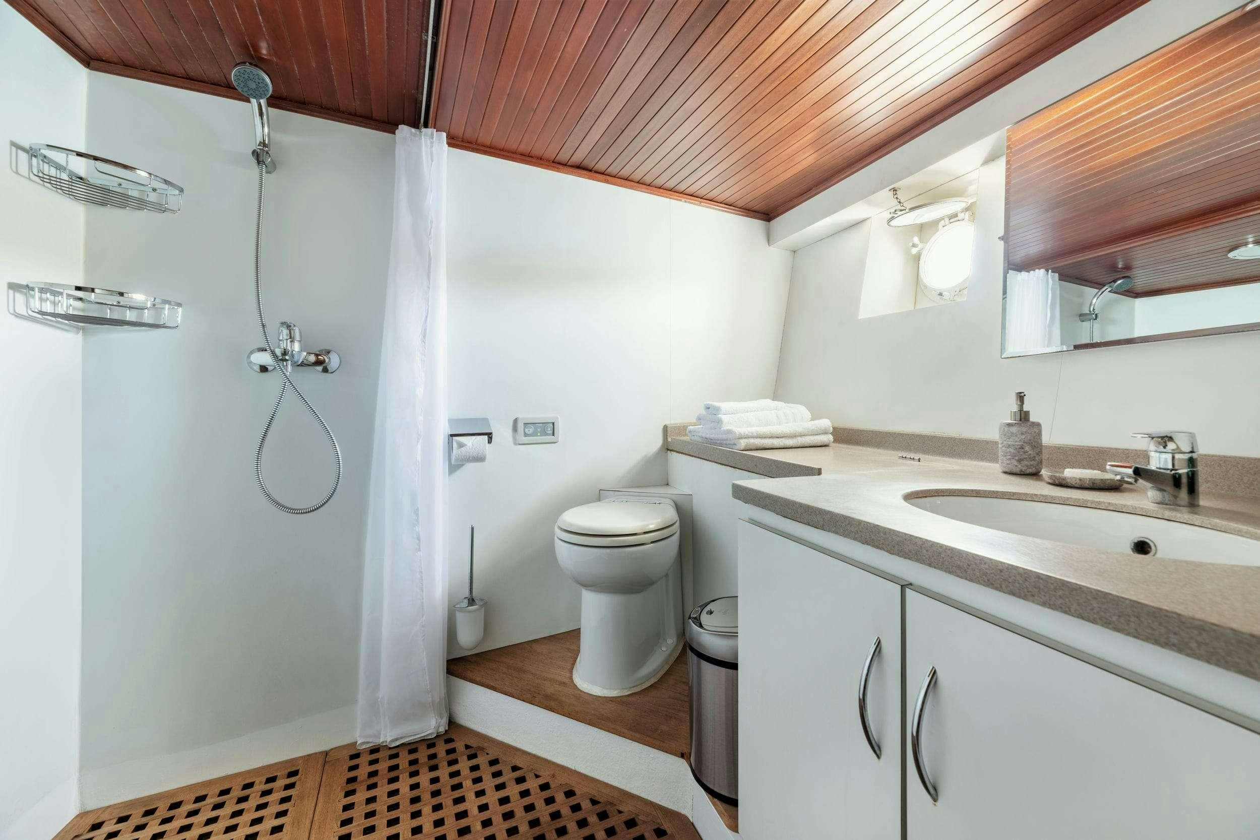 a bathroom with a sink and a toilet aboard LITHI Yacht for Charter