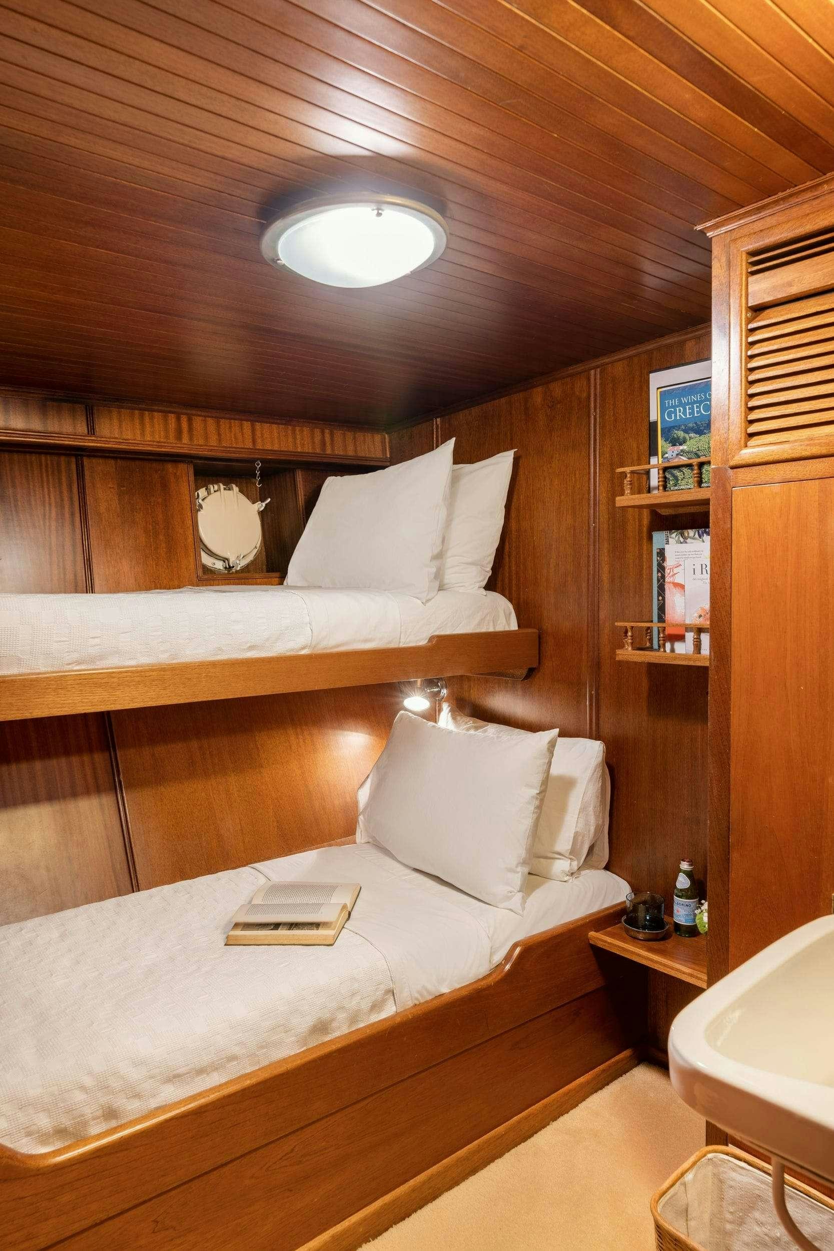 a bed with a white bed aboard LITHI Yacht for Charter