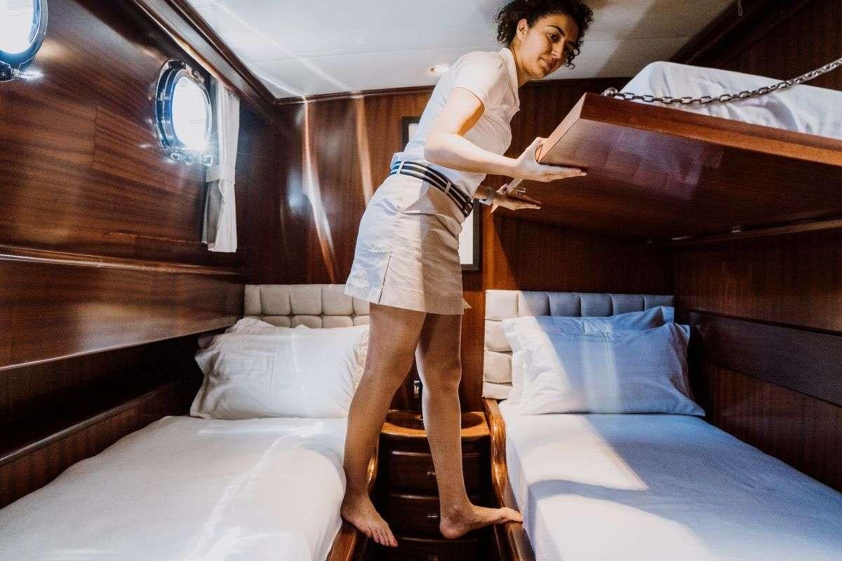 a person standing on a bed aboard CAPRICORN ONE Yacht for Charter