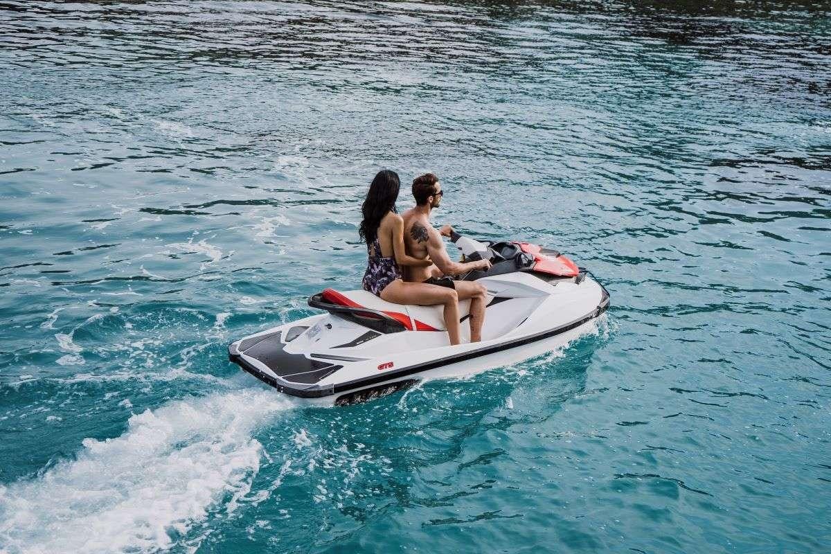 a man and woman on a jet ski aboard CAPRICORN ONE Yacht for Charter