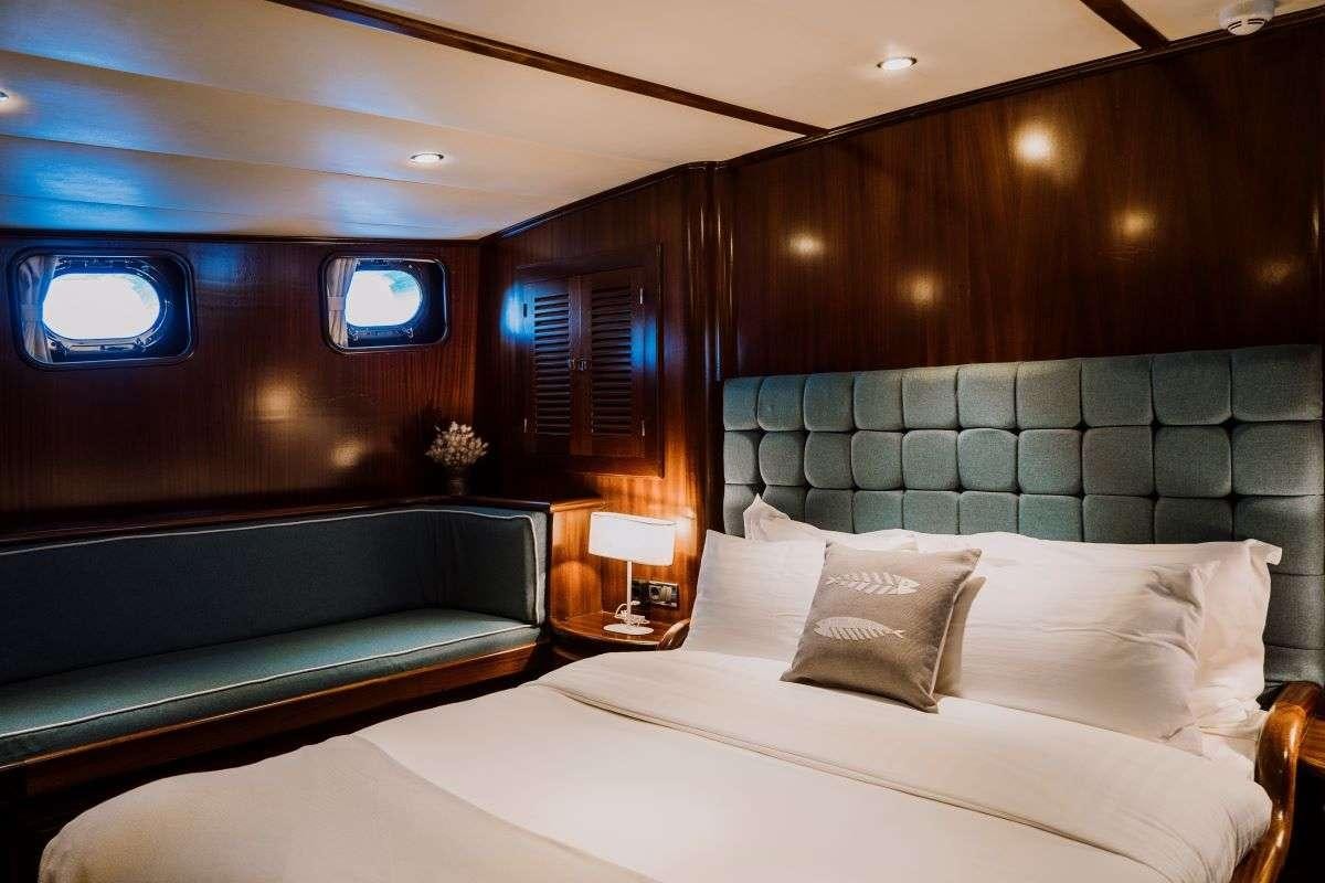 a bed with a large bed aboard CAPRICORN ONE Yacht for Charter