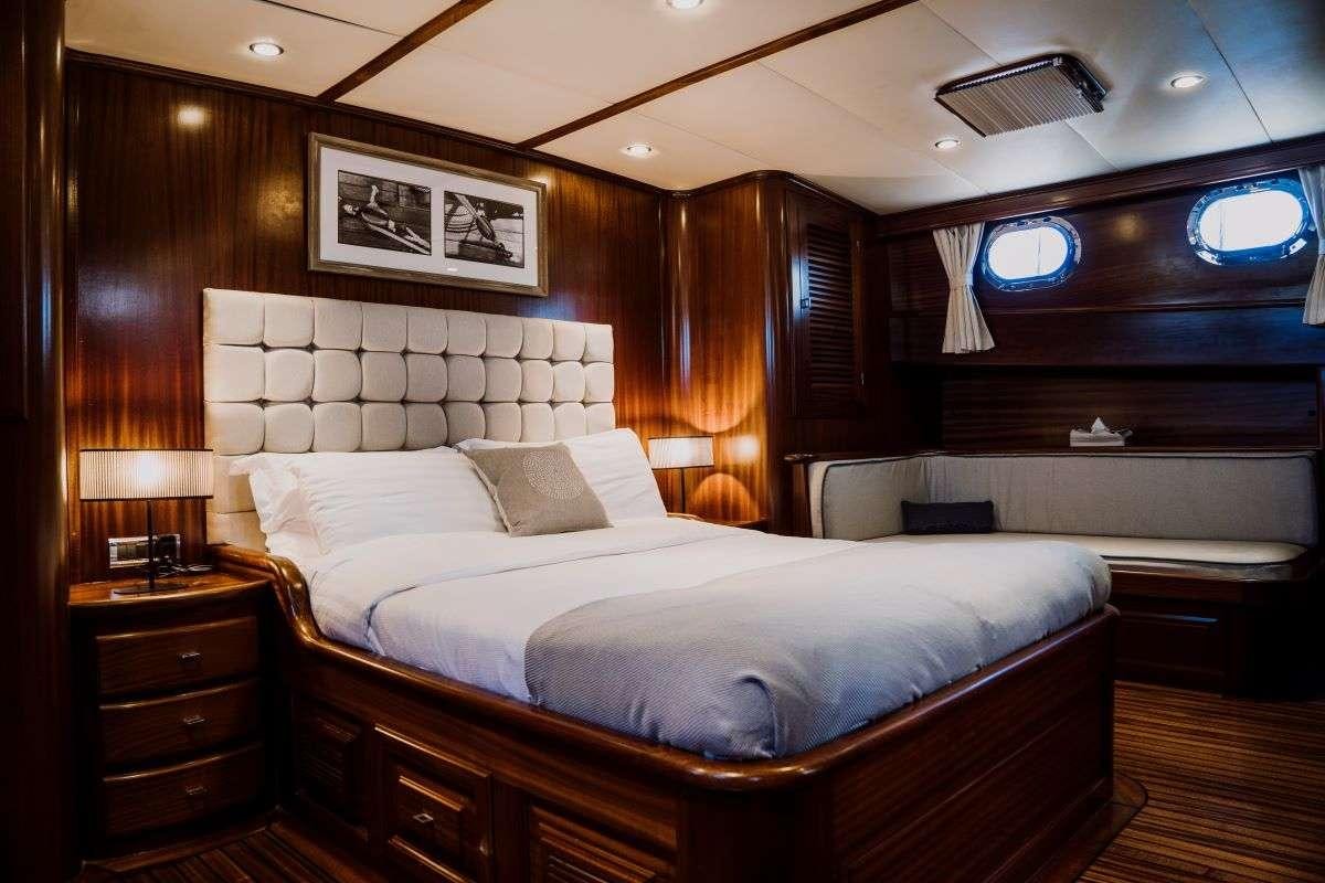 a large bed in a room aboard CAPRICORN ONE Yacht for Charter