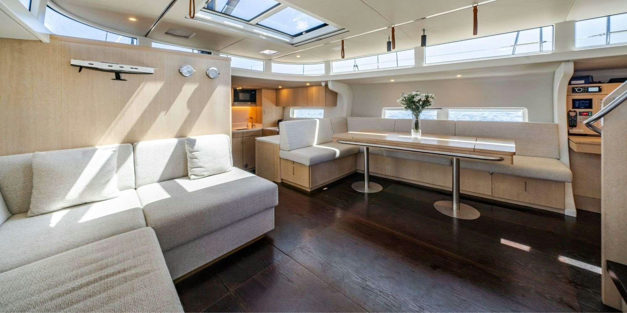 a room with a couch and a table aboard MYSTIC Yacht for Charter