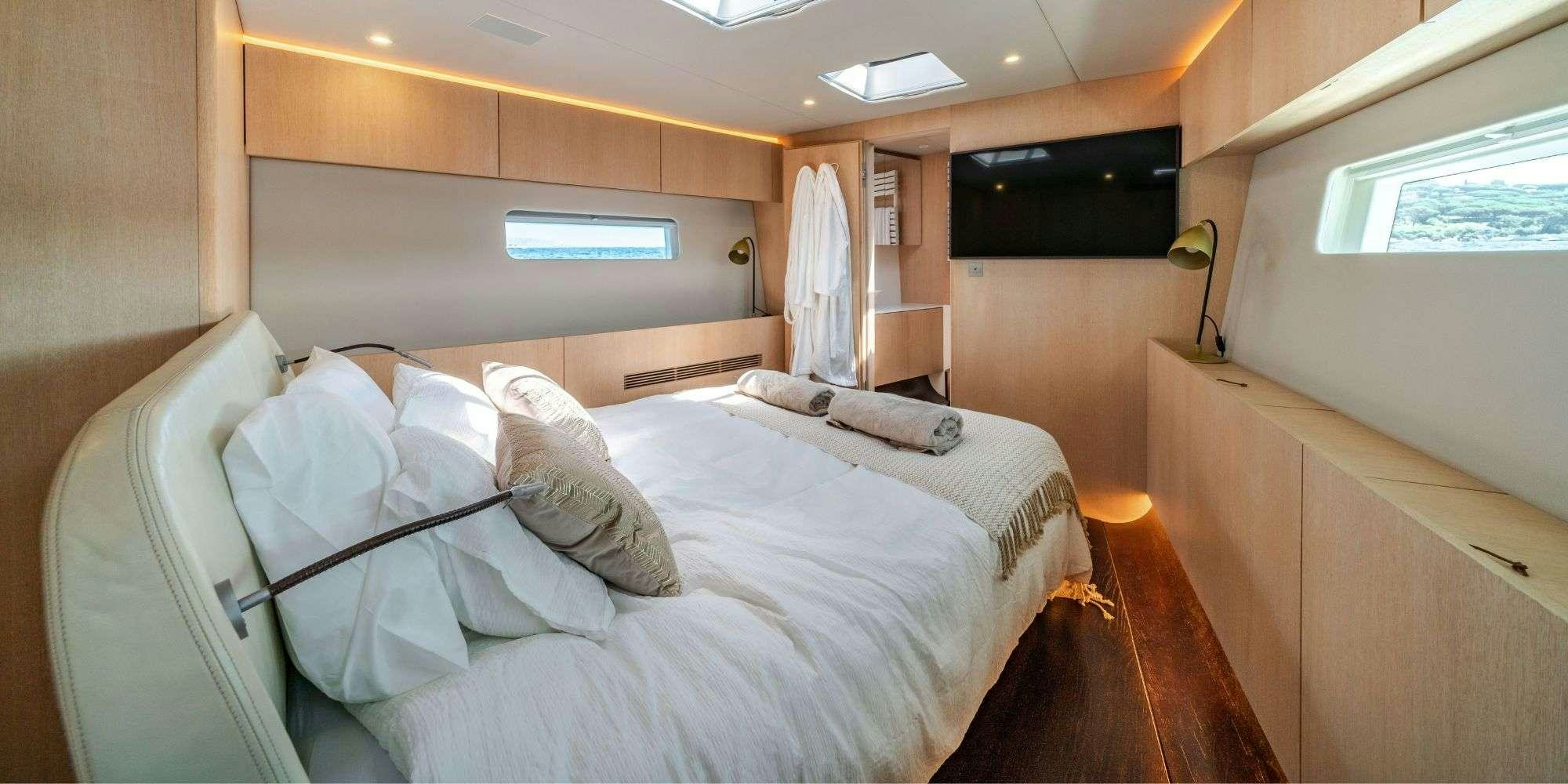 a room with a bed and a window aboard MYSTIC Yacht for Charter