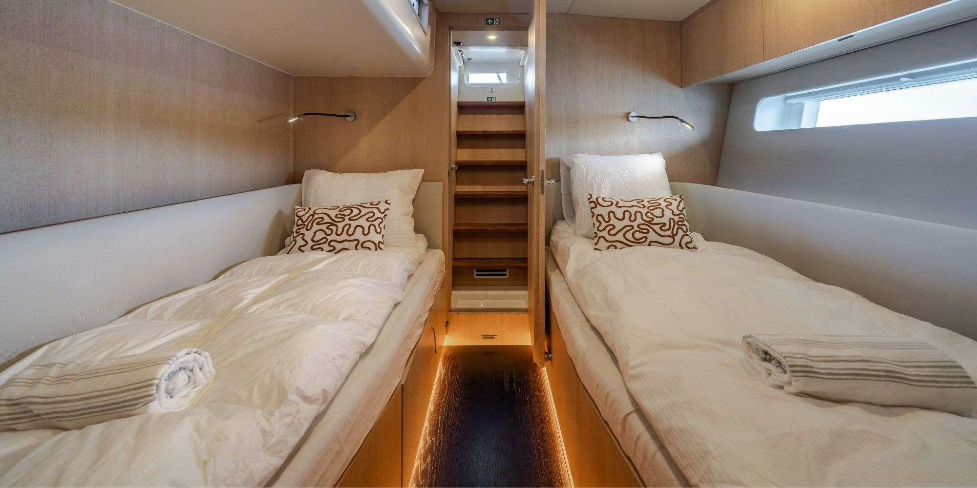 a room with two beds aboard MYSTIC Yacht for Charter