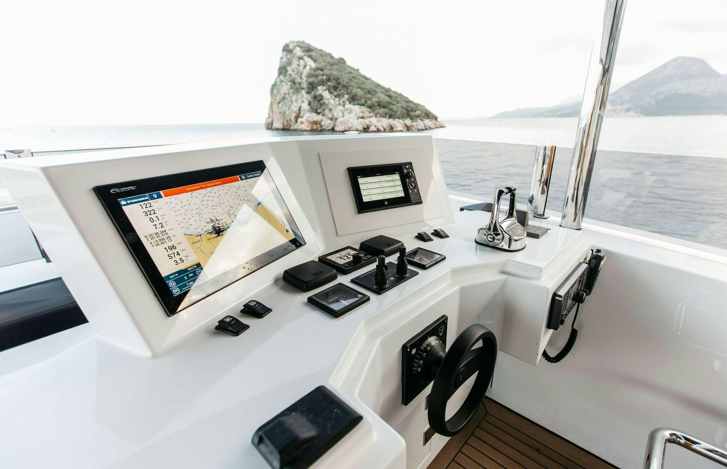 a white counter top with a map on it and a phone on it aboard PAPILLON Yacht for Charter
