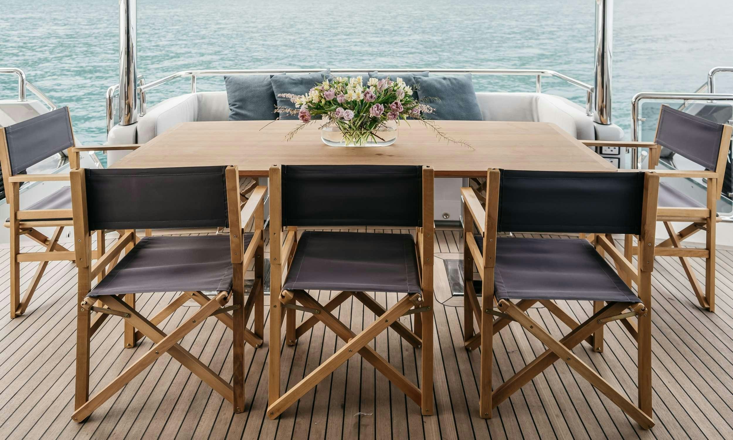 a table with chairs around it aboard PAPILLON Yacht for Charter