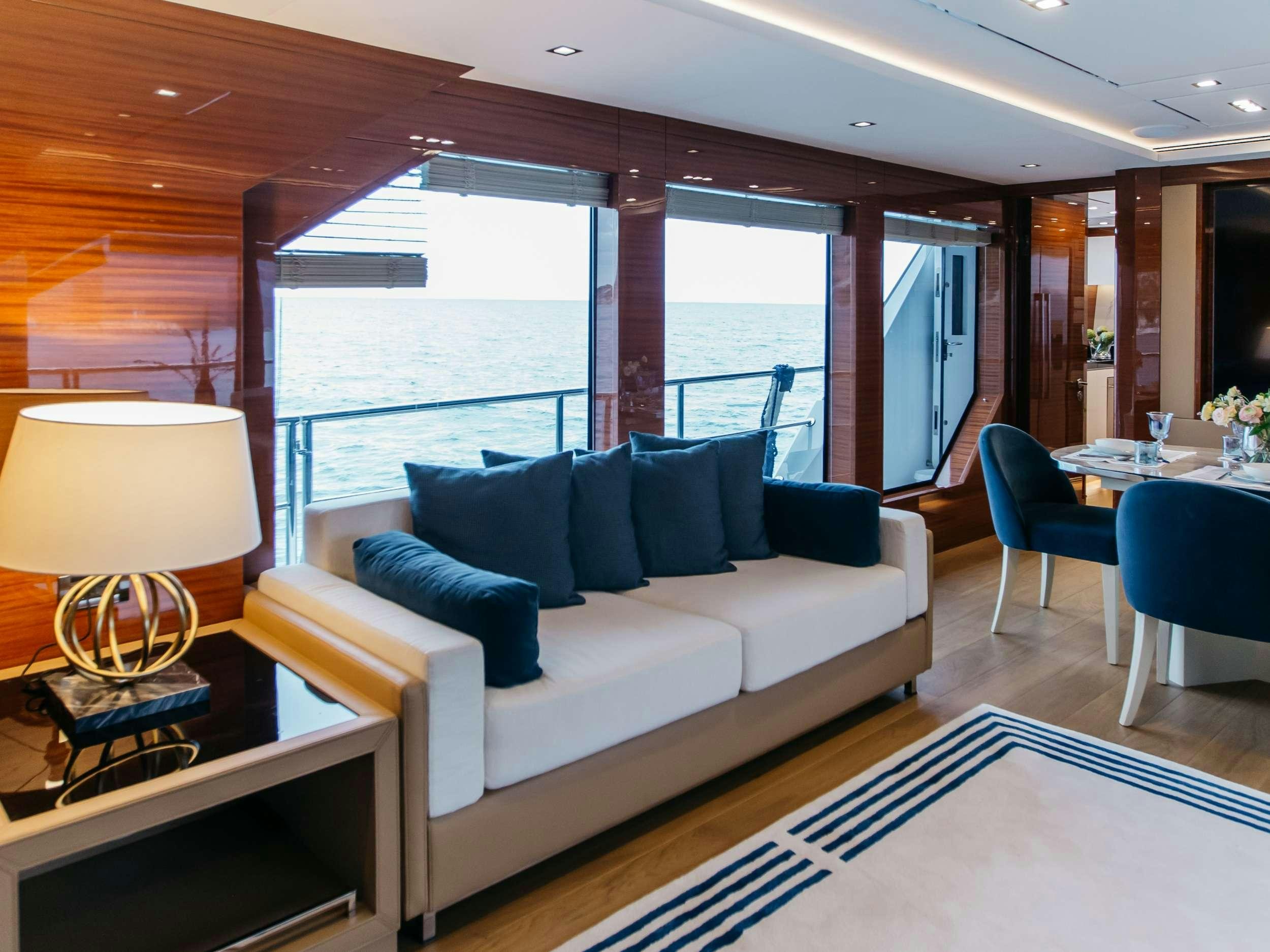 a living room with a large window aboard PAPILLON Yacht for Charter