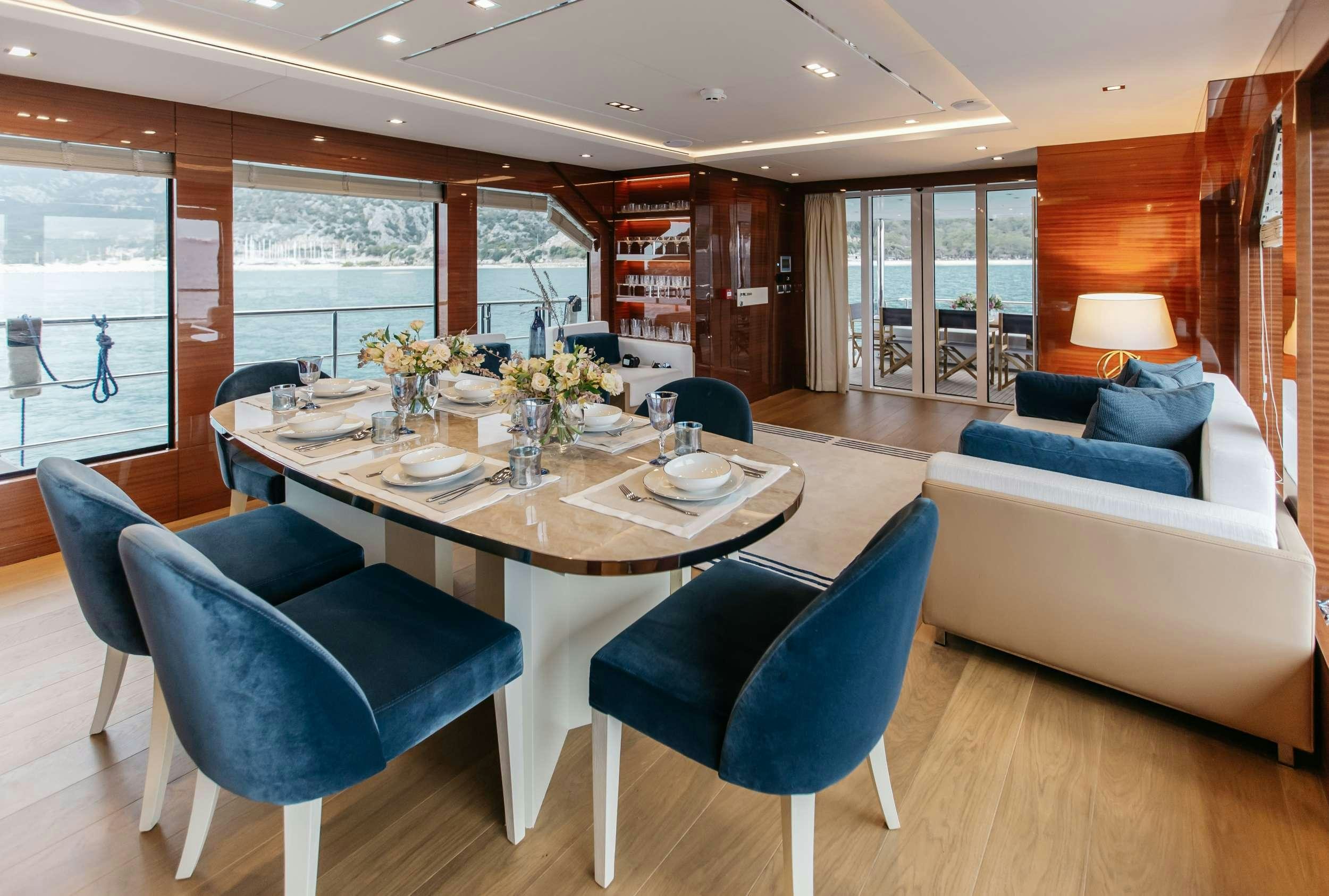 a room with a table and chairs aboard PAPILLON Yacht for Charter