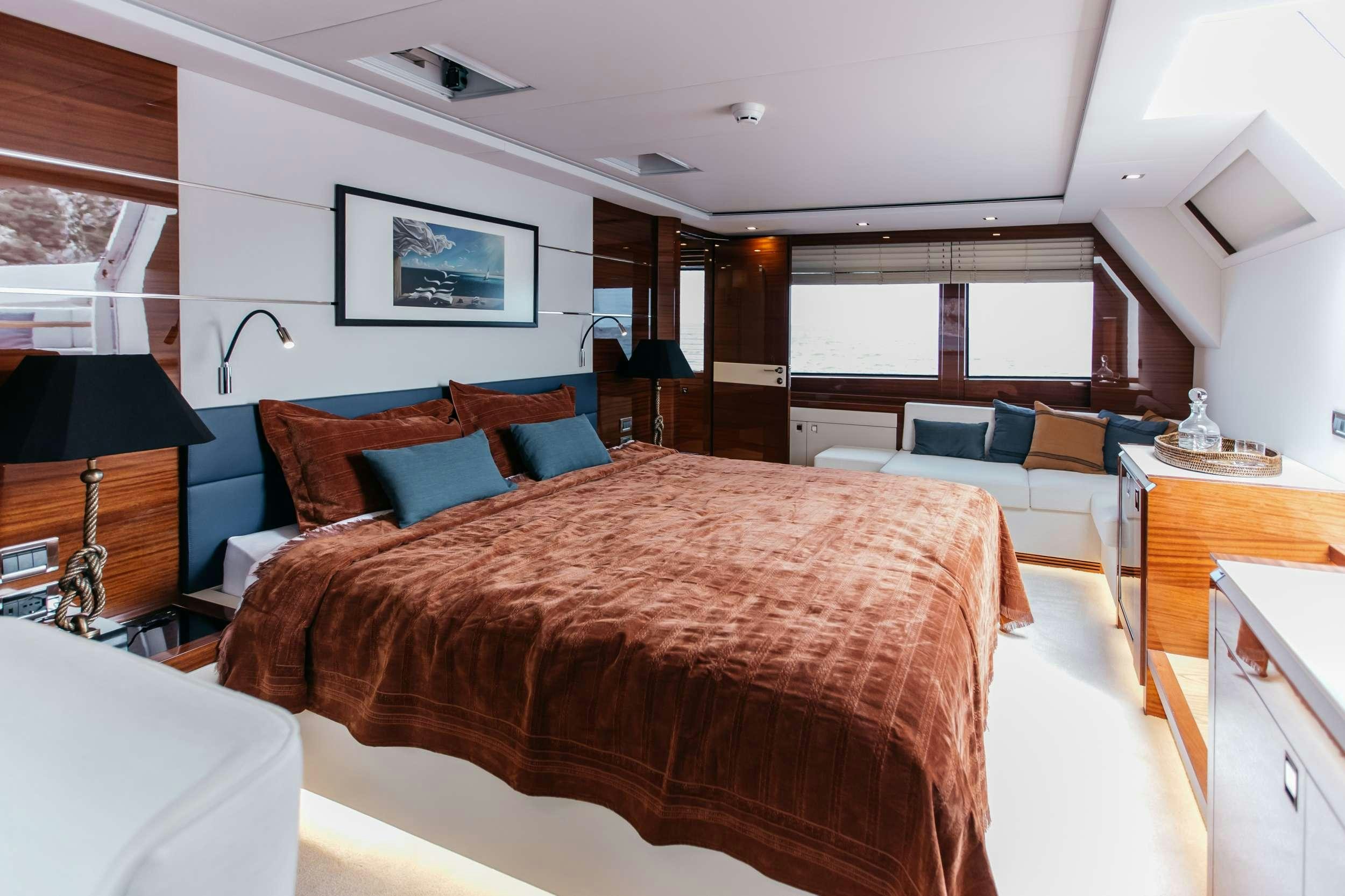 a bedroom with a bed and a couch aboard PAPILLON Yacht for Charter