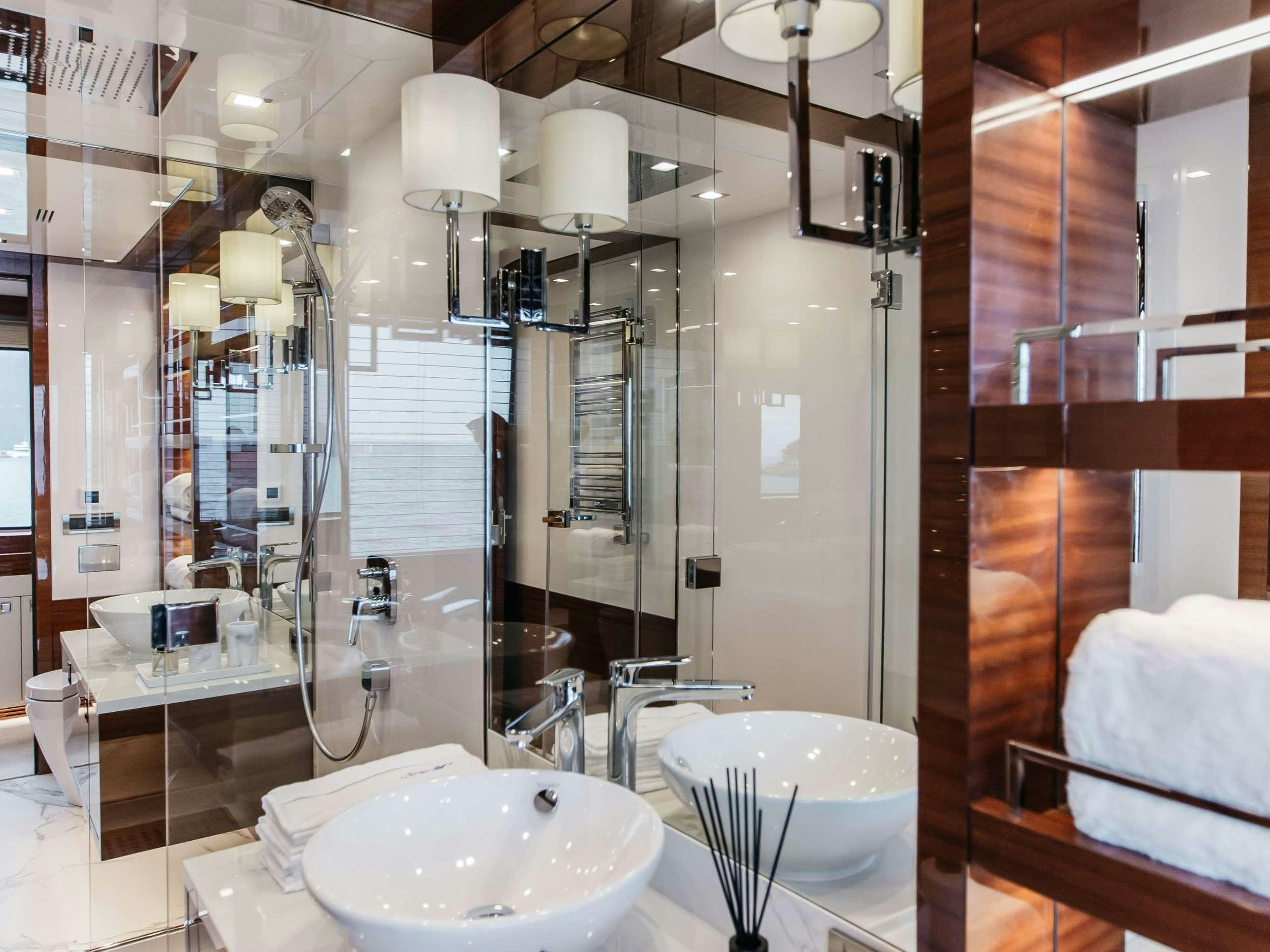 a bathroom with a large mirror aboard PAPILLON Yacht for Charter