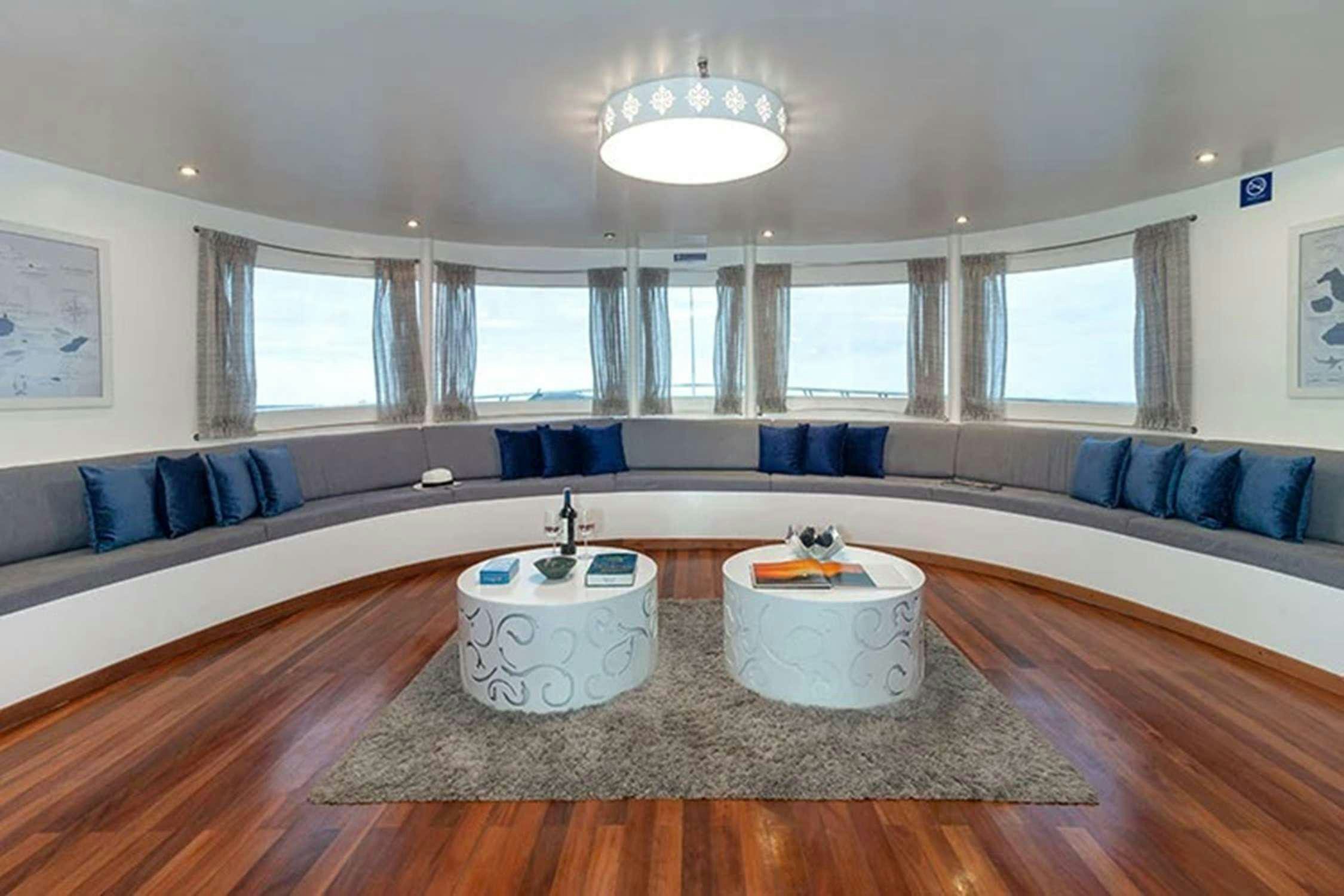 a living room with a couch and a table aboard GALAPAGOS HORIZON Yacht for Charter