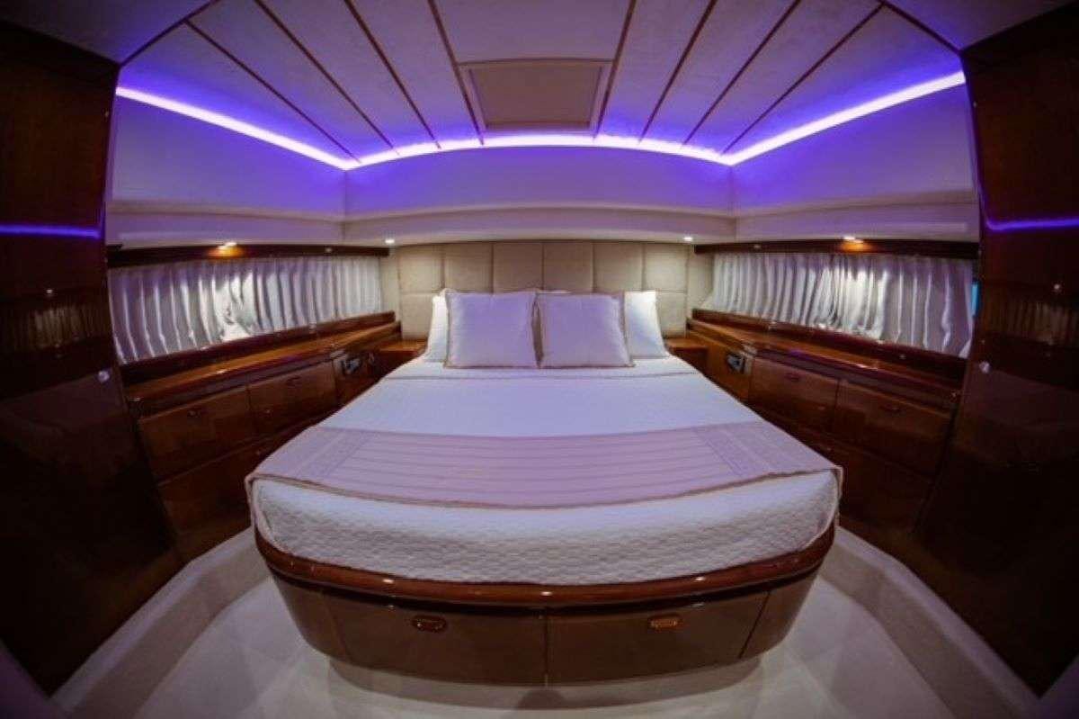 a room with a bed and a purple ceiling aboard HASARD Yacht for Charter