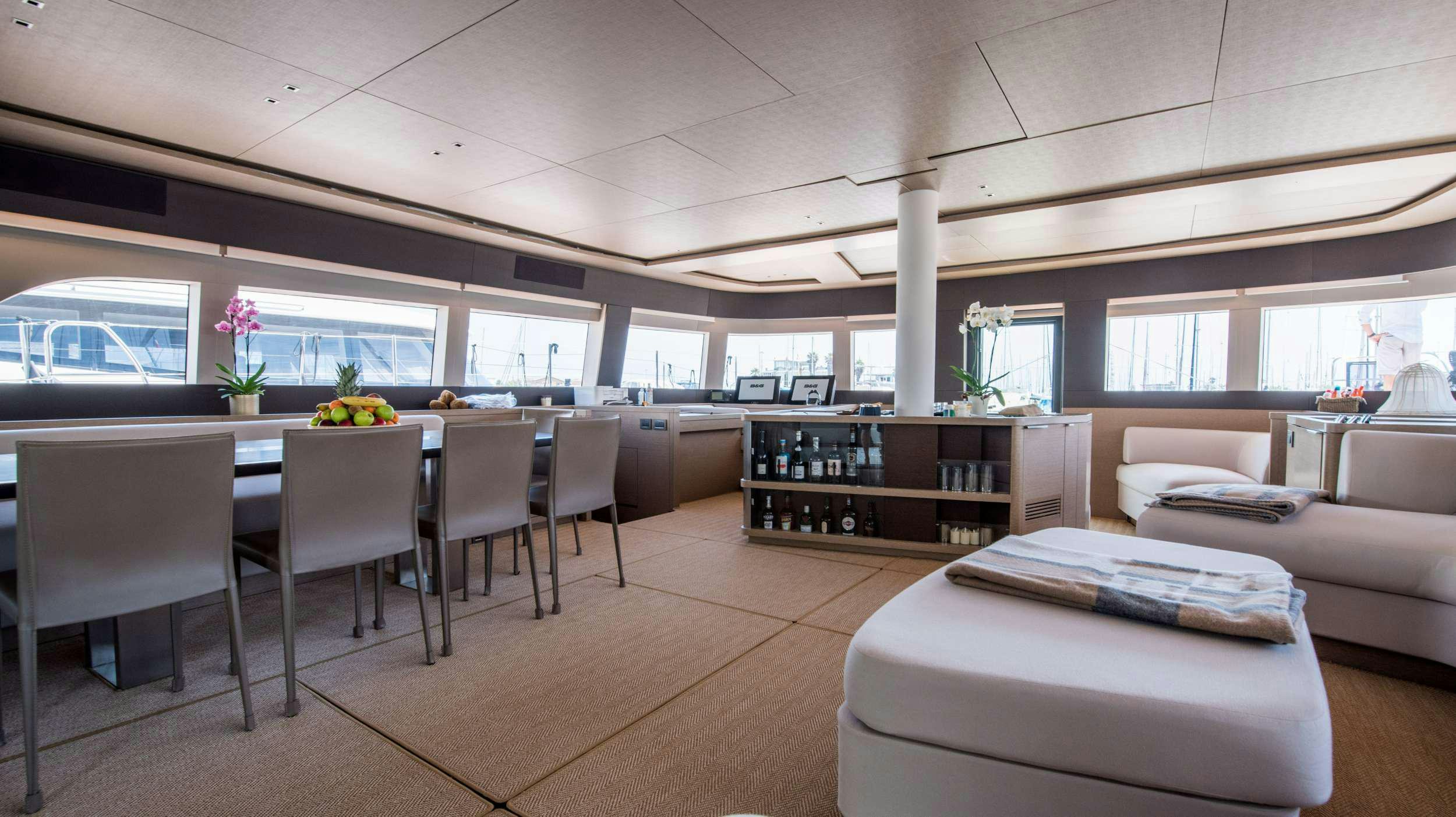 a room with a couch and a table and chairs aboard CAT TUA Yacht for Charter