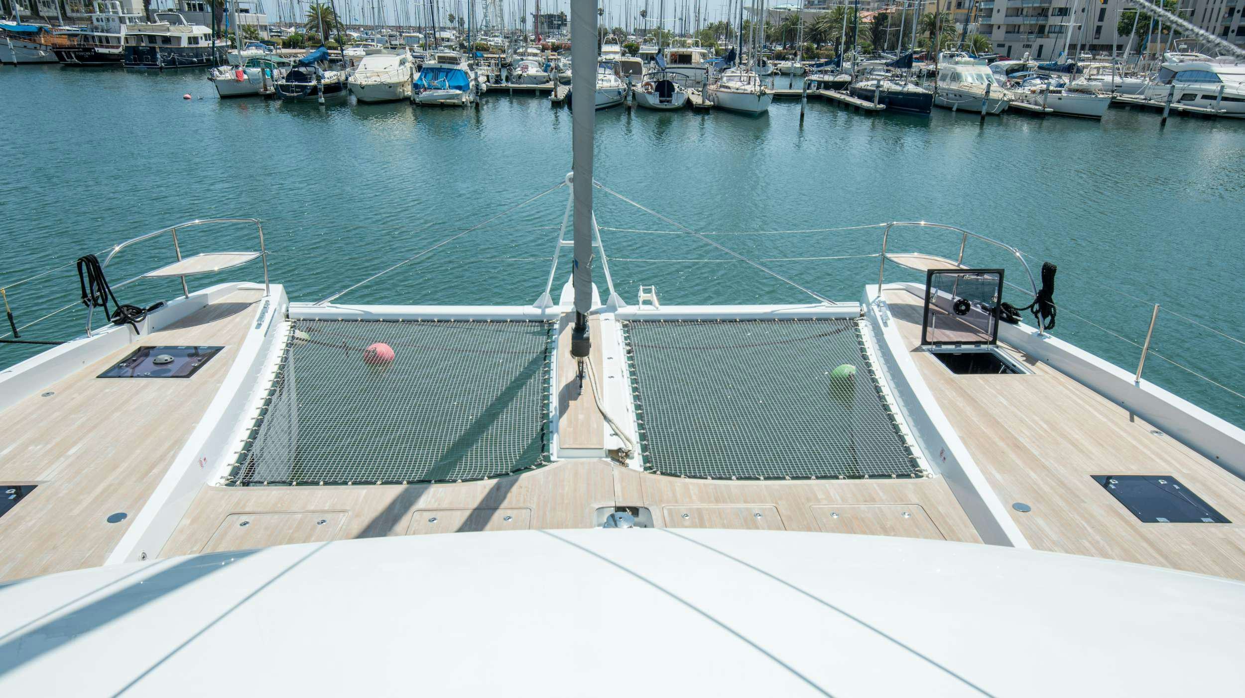 a boat dock with boats aboard CAT TUA Yacht for Charter