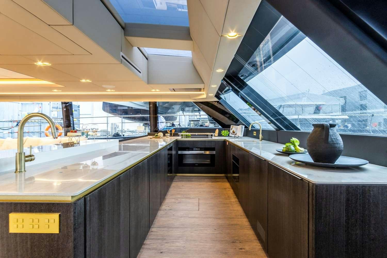 a kitchen with a large island aboard MANTA Yacht for Charter