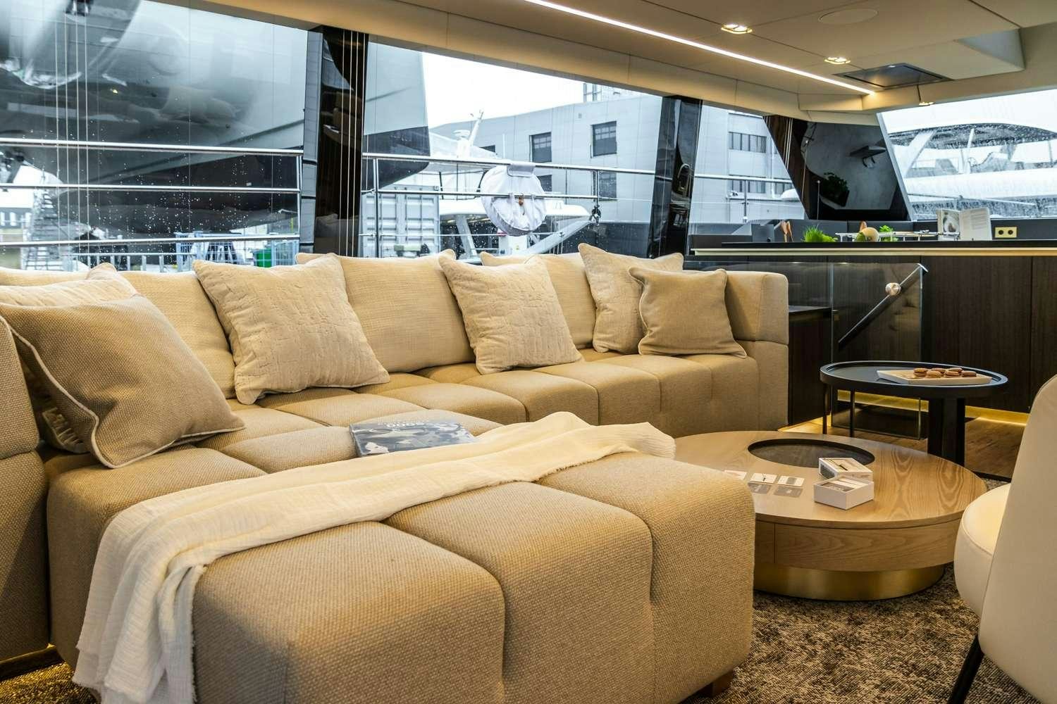a living room with a couch and a table aboard MANTA Yacht for Charter