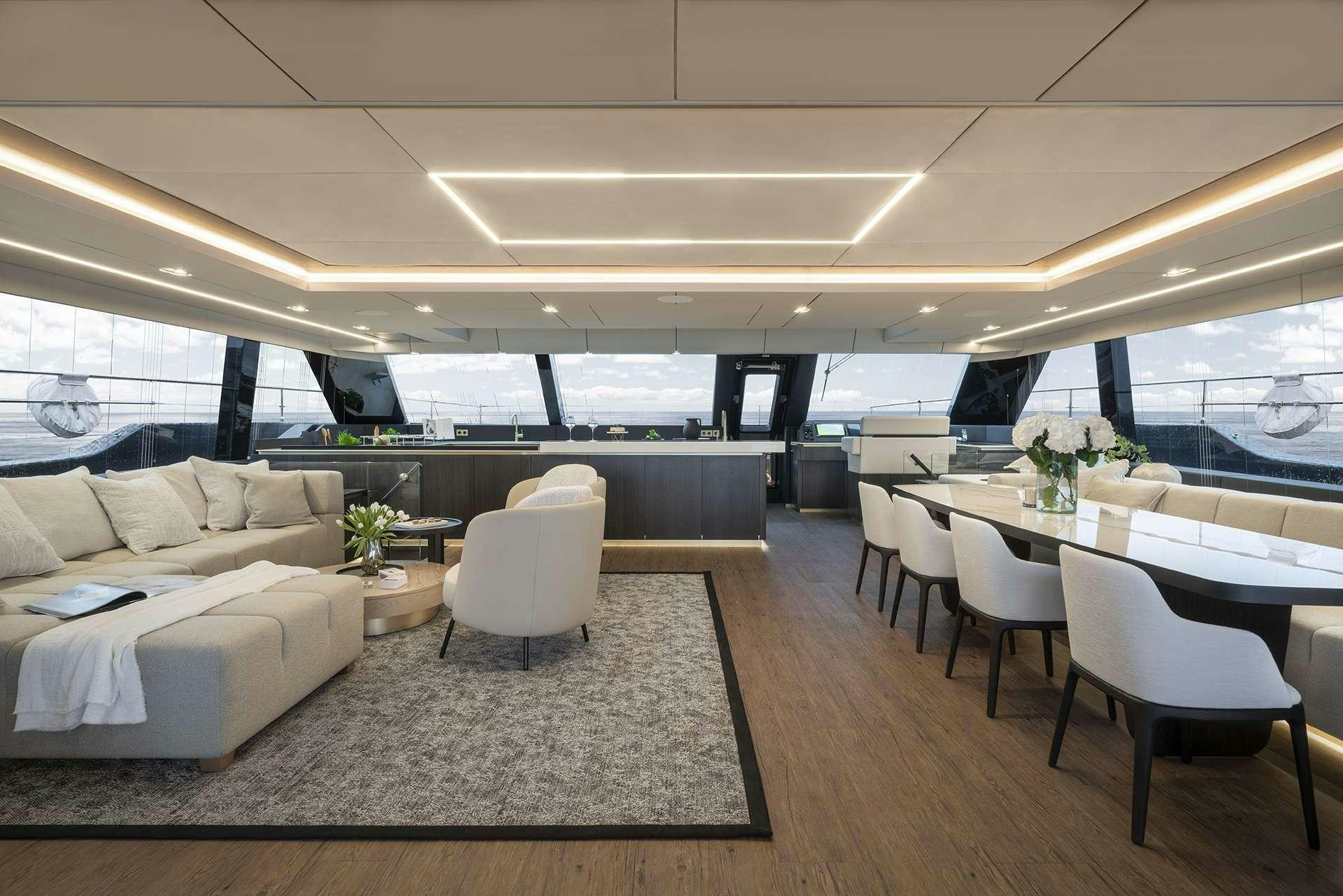 a room with a couch and a table and chairs aboard MANTA Yacht for Charter