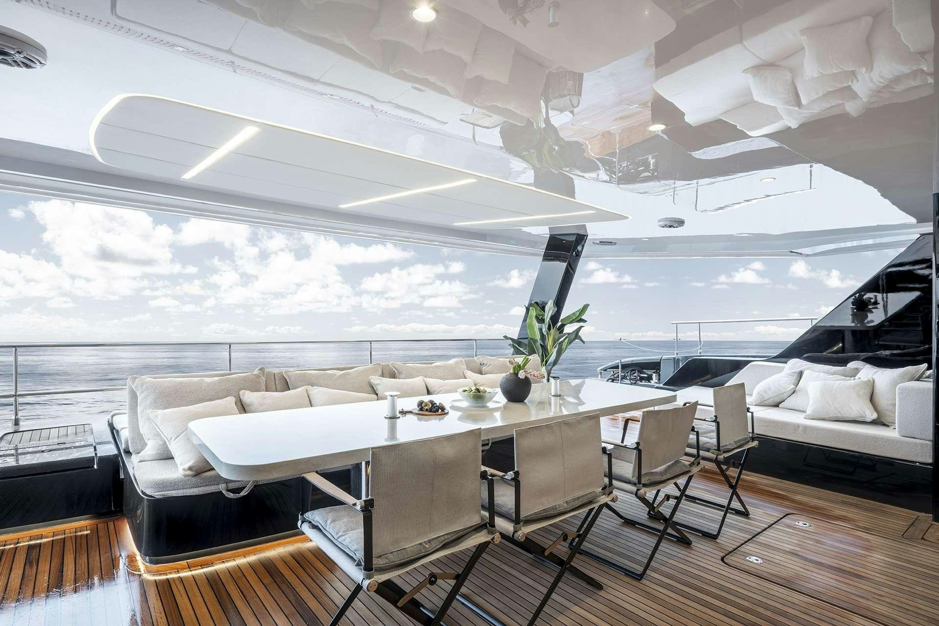 a room with a table and chairs aboard MANTA Yacht for Charter