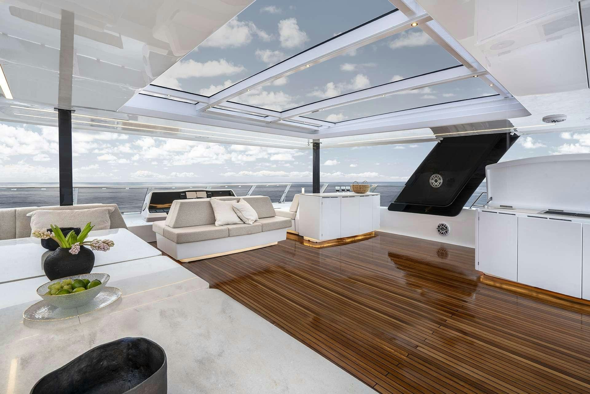 a room with a table and a couch aboard MANTA Yacht for Charter