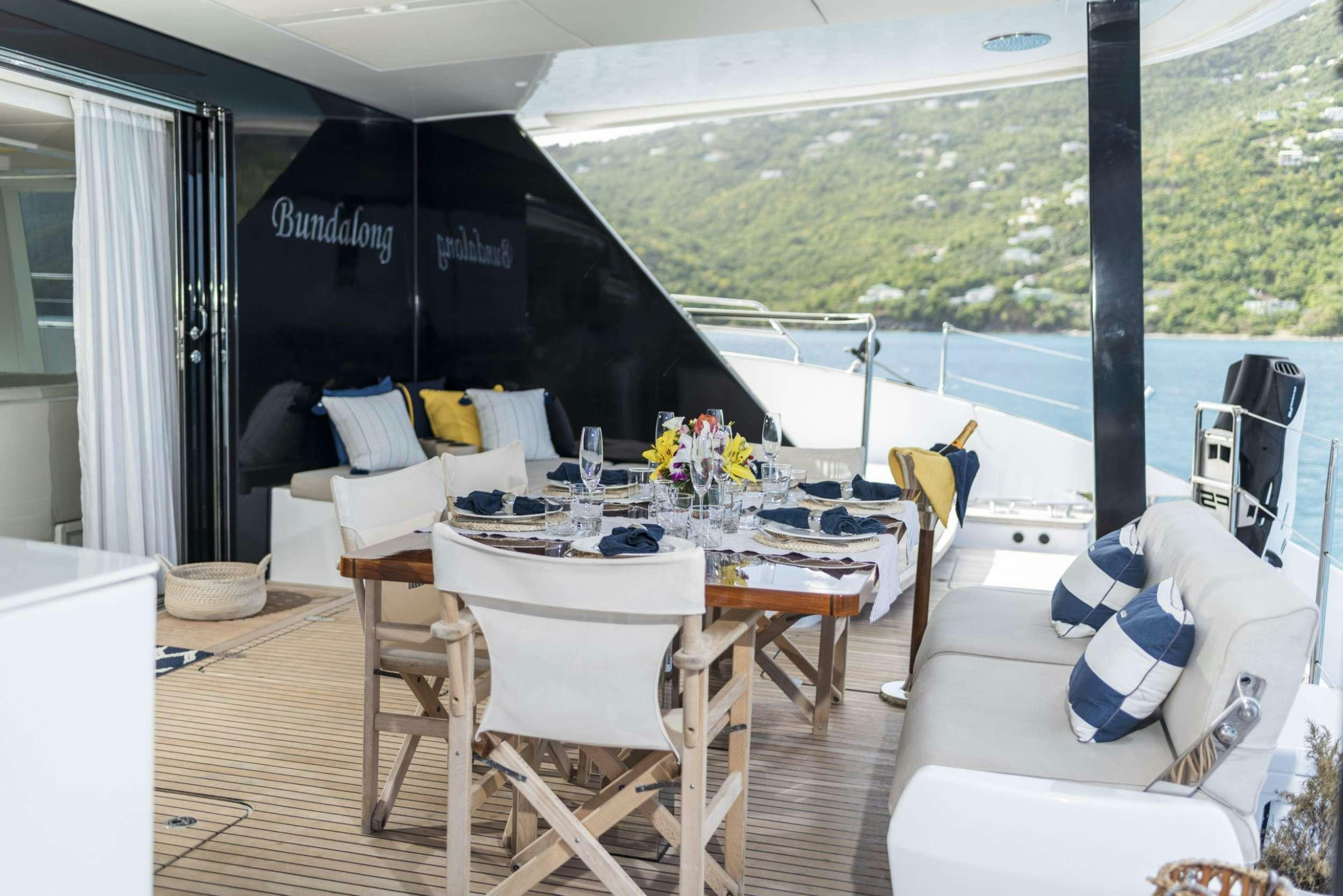 a table and chairs on a deck aboard BUNDALONG Yacht for Charter