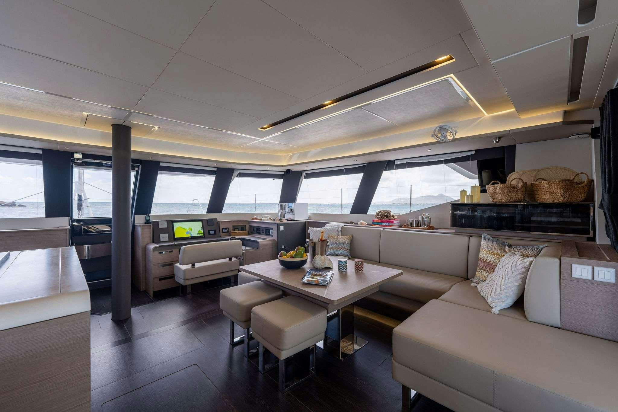 a living room with a couch and a table aboard LIQUID SKY Yacht for Charter