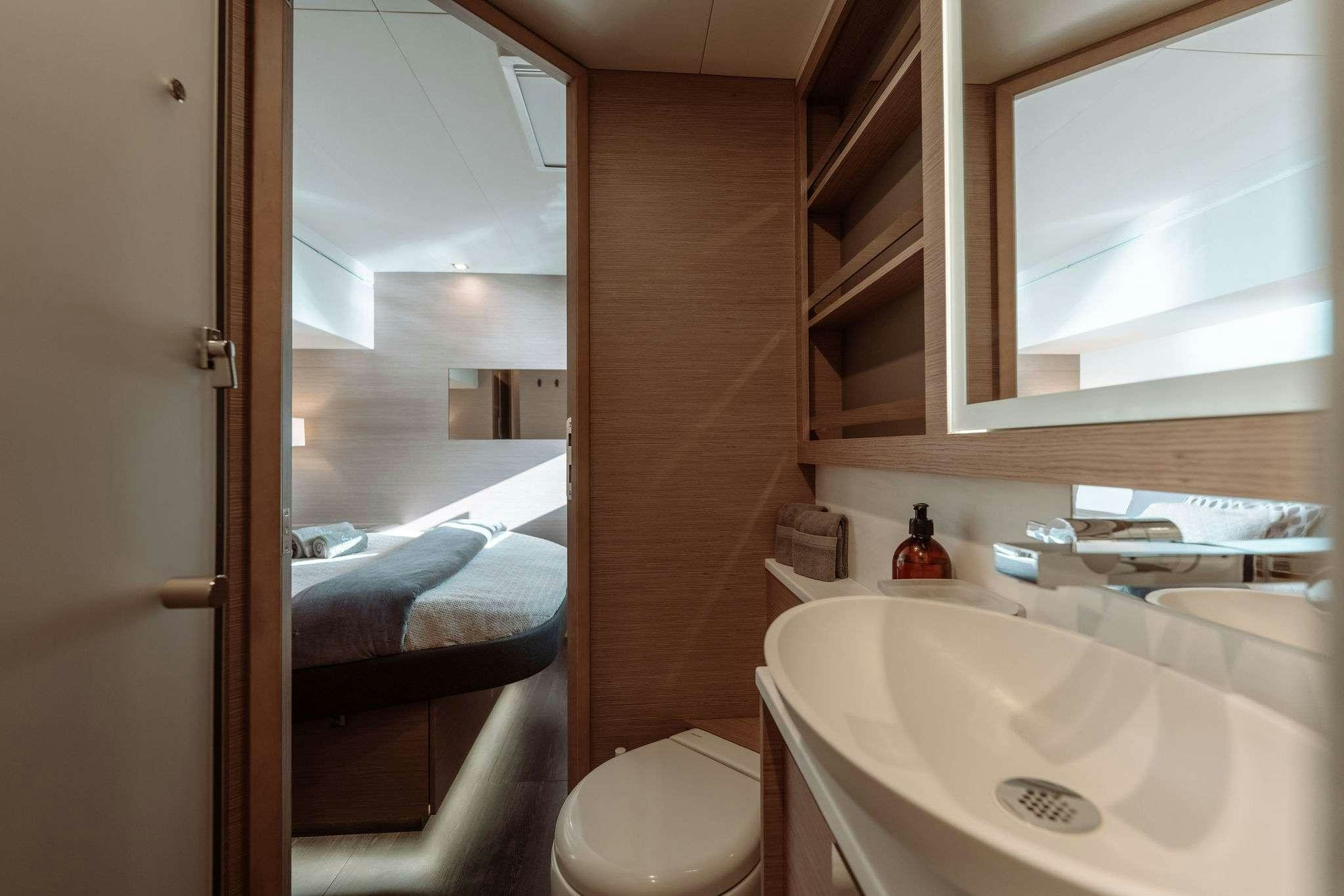 a bathroom with a sink and a mirror aboard LIQUID SKY Yacht for Charter
