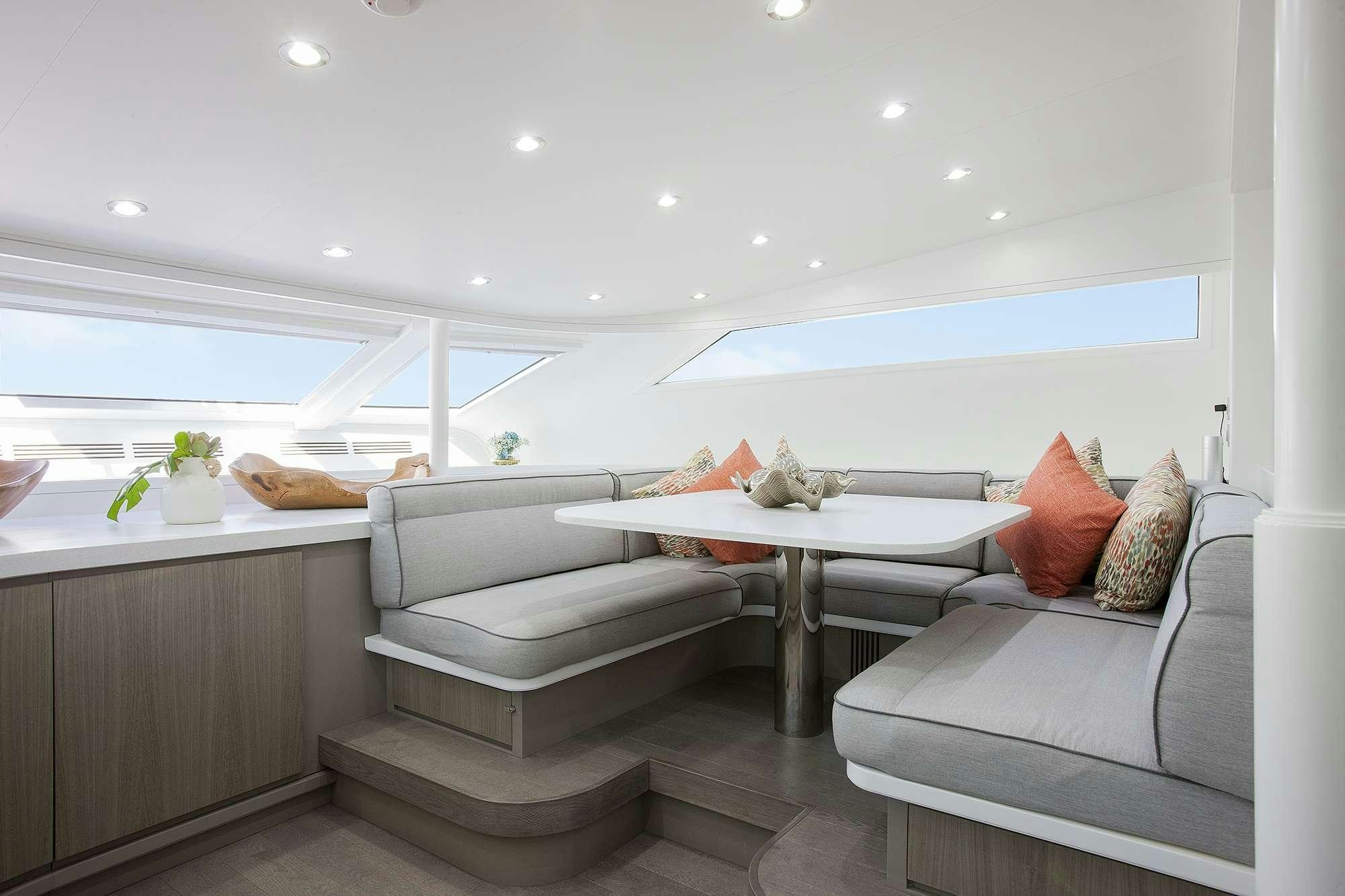 a room with a couch and a table aboard DADDY Yacht for Charter