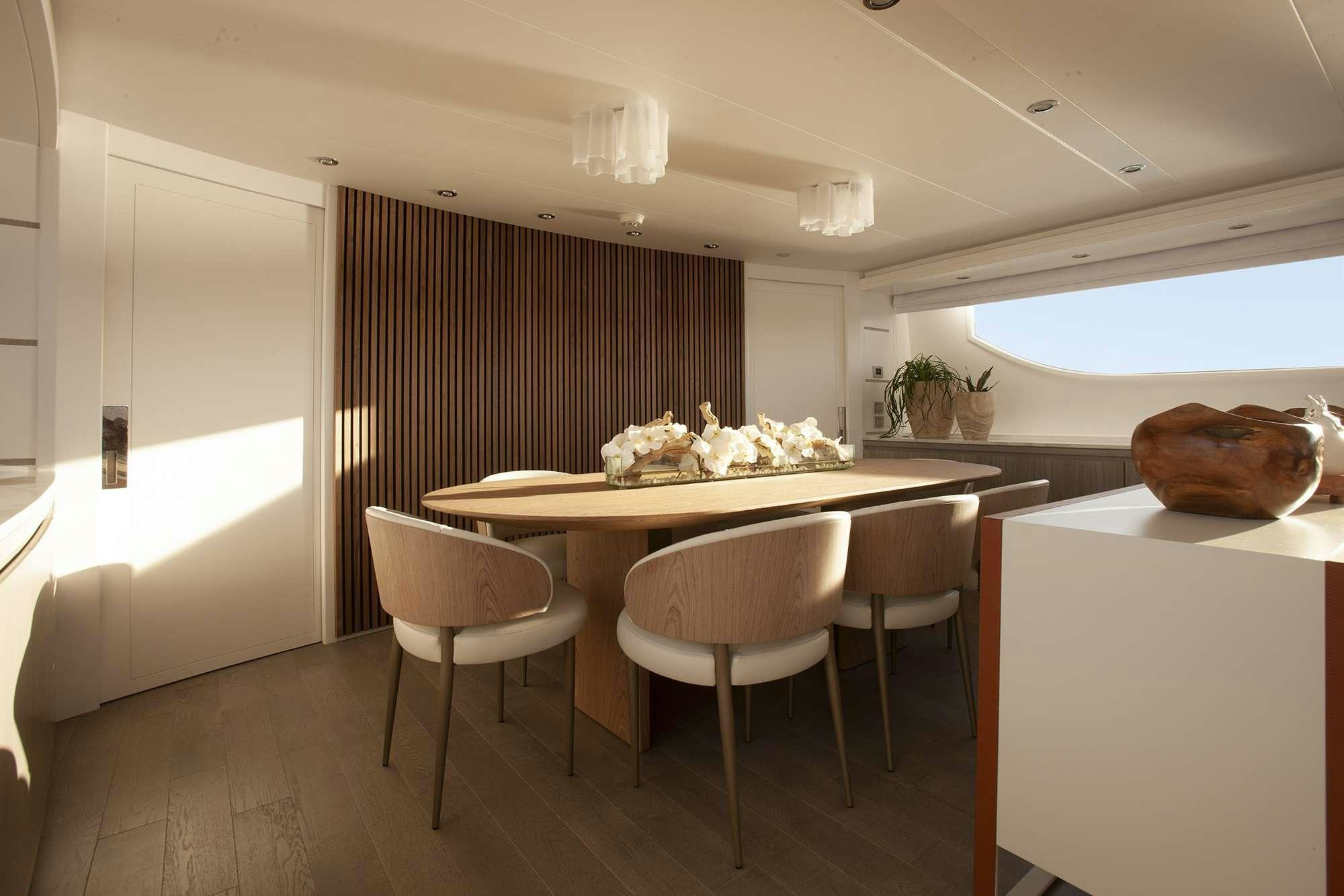 a room with a table and chairs aboard DADDY Yacht for Charter