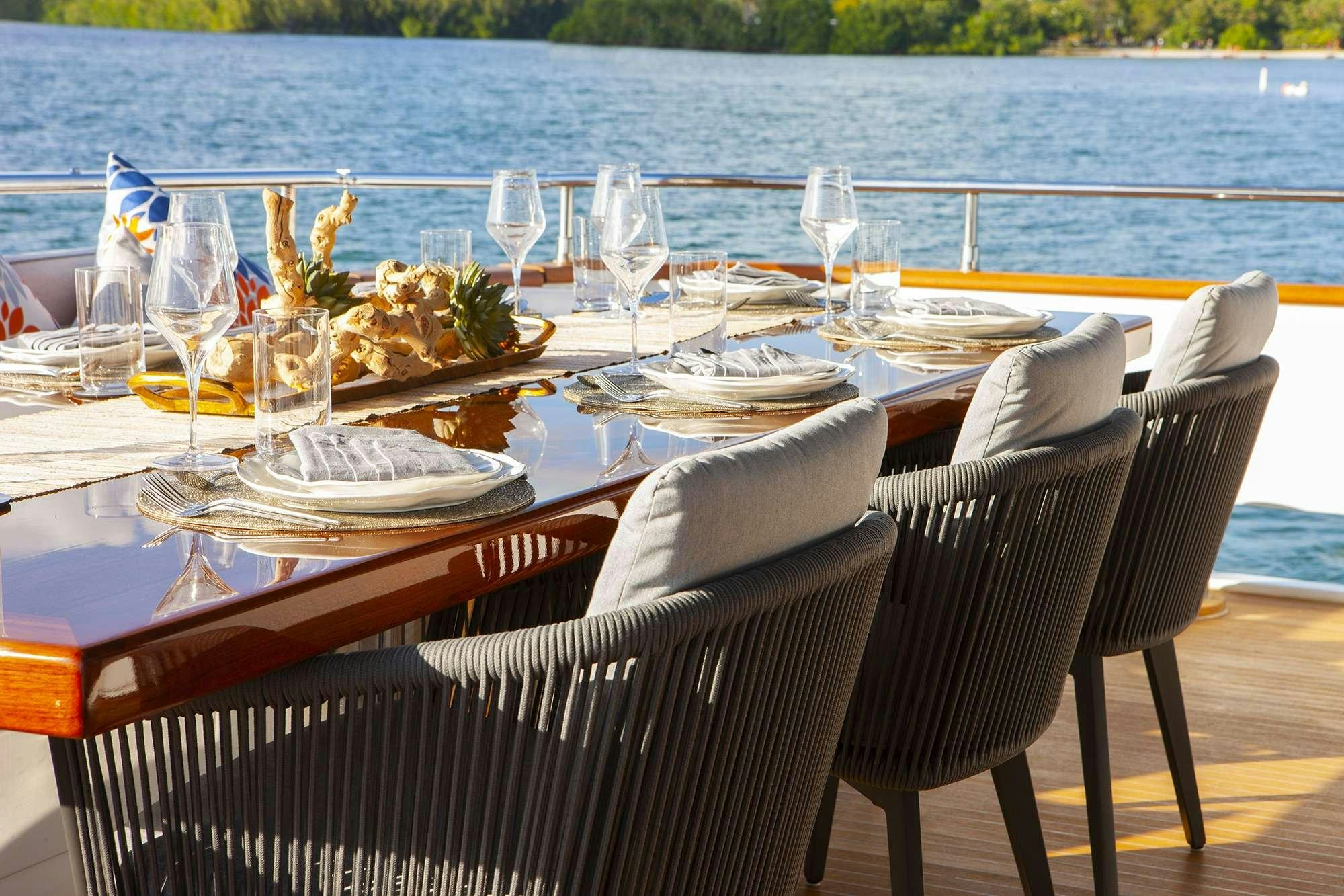 a table set for a dinner aboard DADDY Yacht for Charter