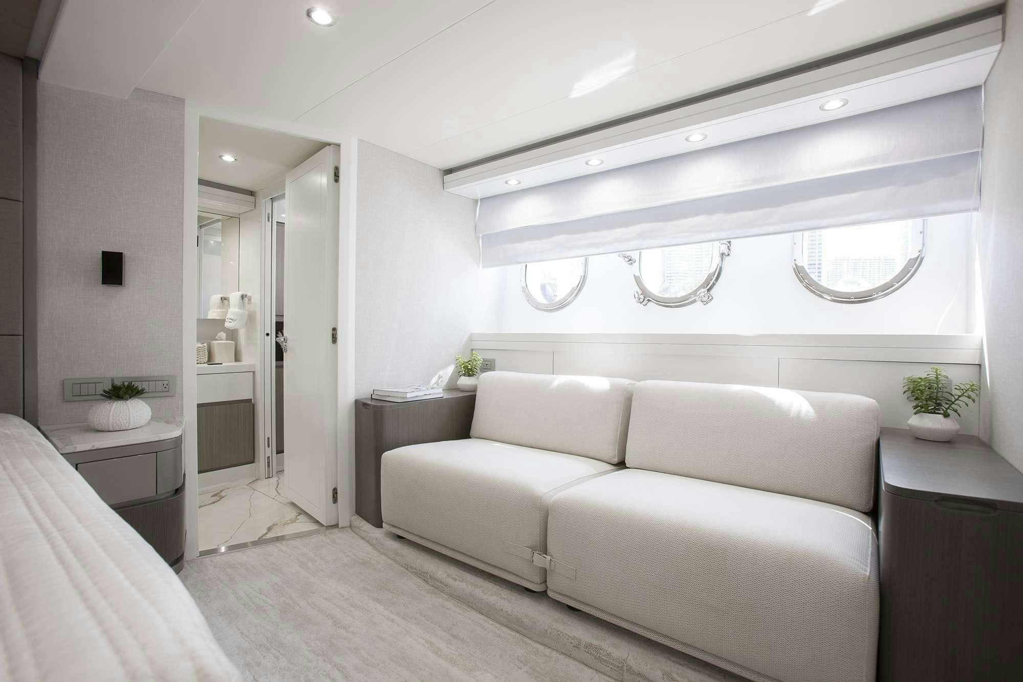a white couch in a room aboard DADDY Yacht for Charter