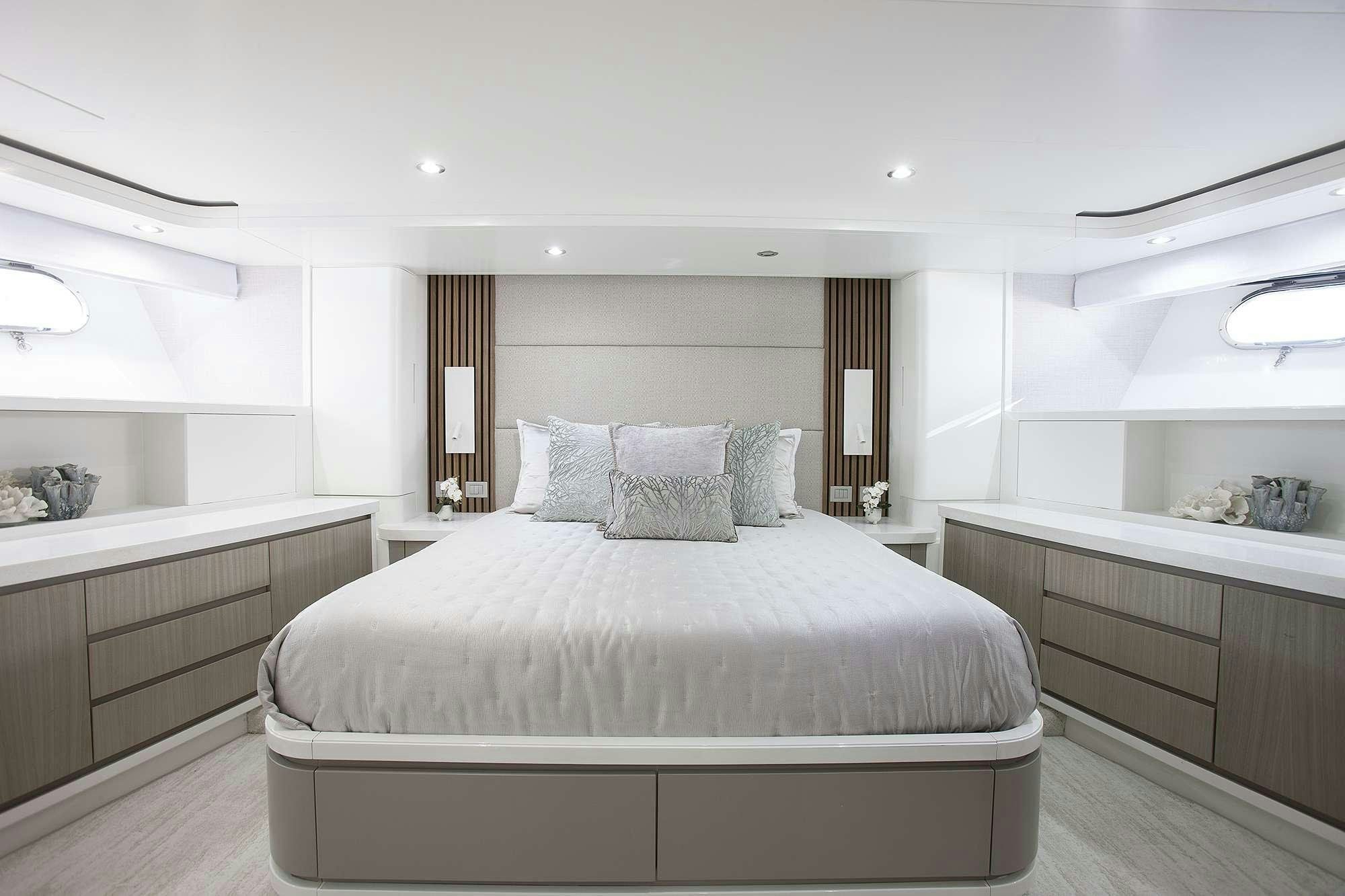 a large bedroom with a large bed aboard DADDY Yacht for Charter