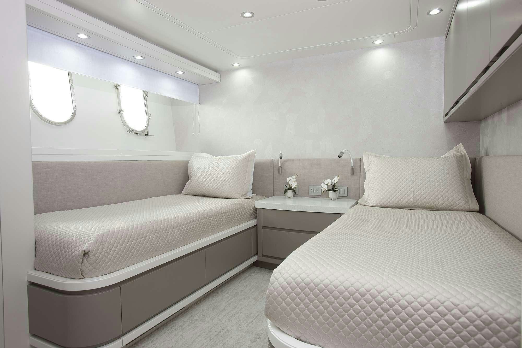 a couple of beds in a room aboard DADDY Yacht for Charter