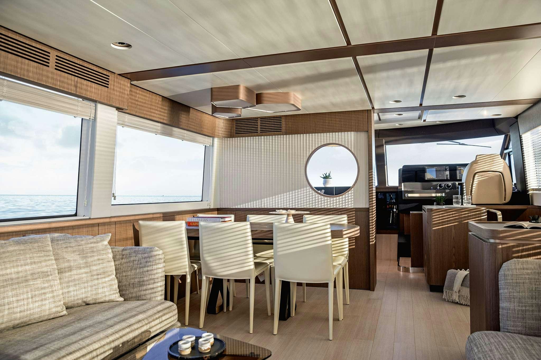 a room with a table chairs and a couch aboard AZIMUT MAGHELLANO 66 Yacht for Charter