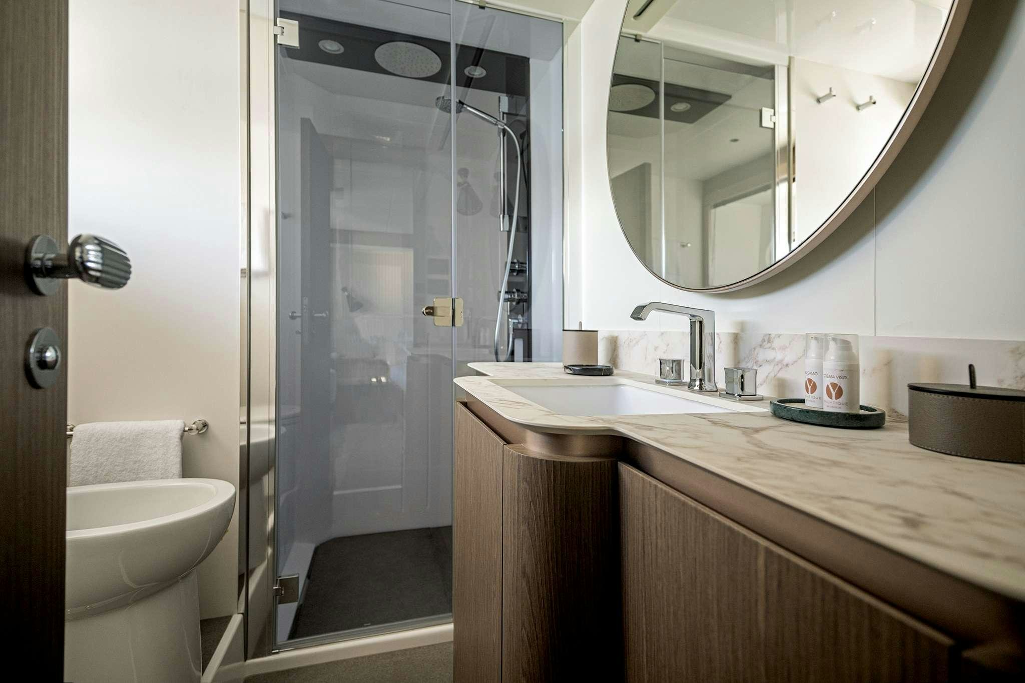 a bathroom with a glass shower aboard AZIMUT MAGHELLANO 66 Yacht for Charter