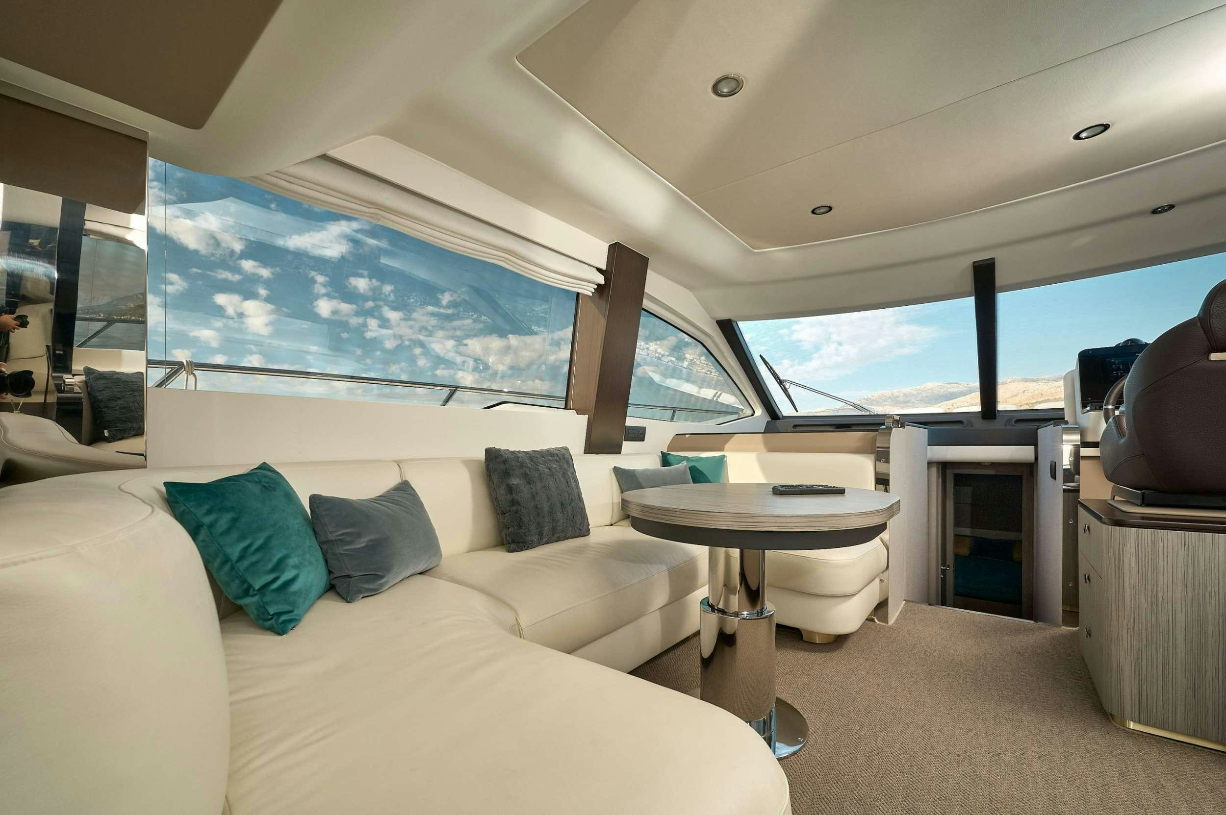 a room with a bed and a table aboard AZIMUT 55 FLY - AMPARITO IV Yacht for Charter