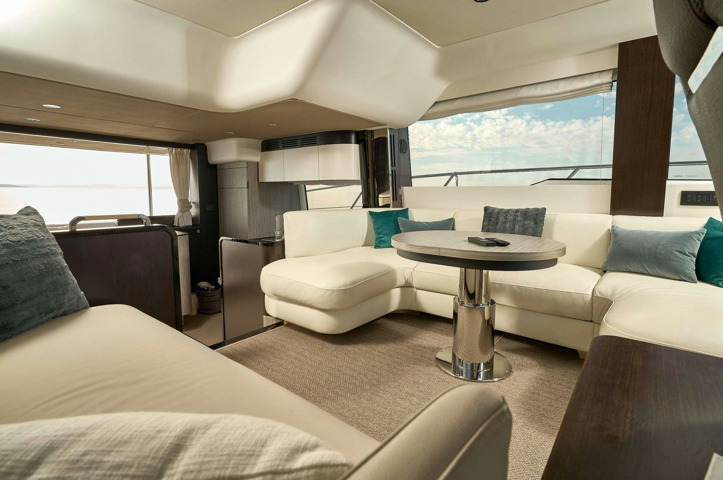 a room with a table and couches aboard AZIMUT 55 FLY - AMPARITO IV Yacht for Charter