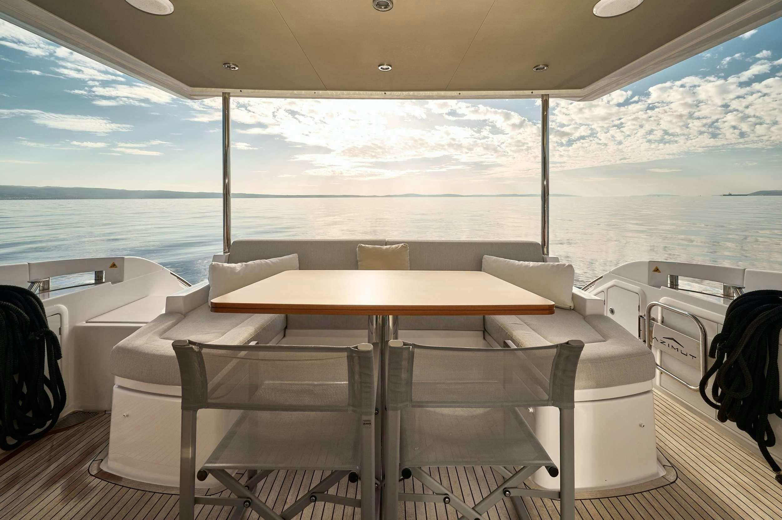 a room with a table and chairs aboard AZIMUT 55 FLY - AMPARITO IV Yacht for Charter