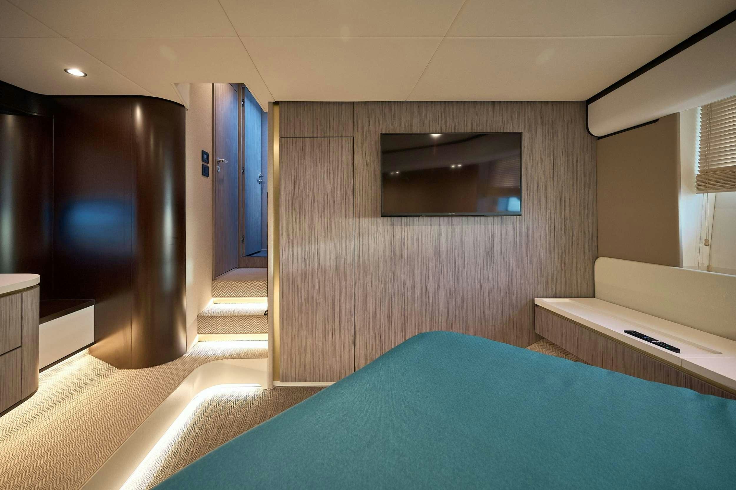 a room with a bed and a tv aboard AZIMUT 55 FLY - AMPARITO IV Yacht for Charter