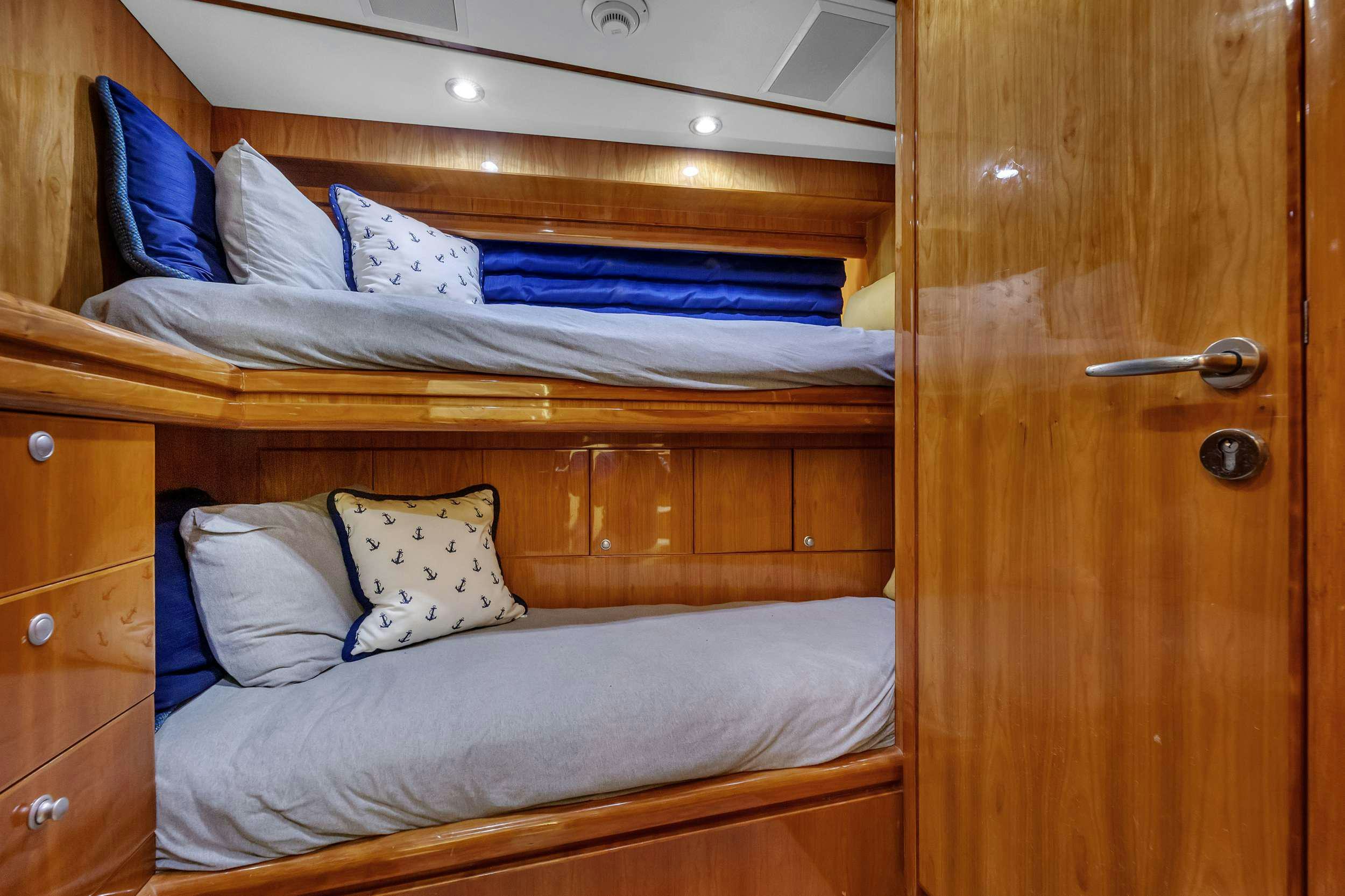 a bed with white sheets aboard DREAM ON Yacht for Charter
