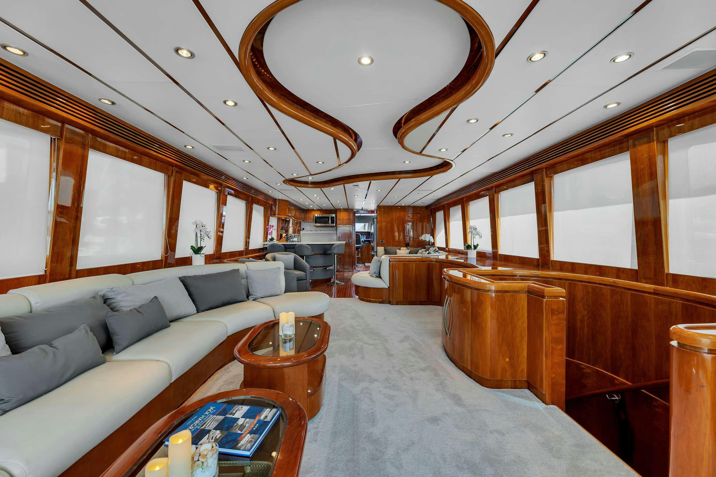 a large living room with a large chandelier aboard DREAM ON Yacht for Charter